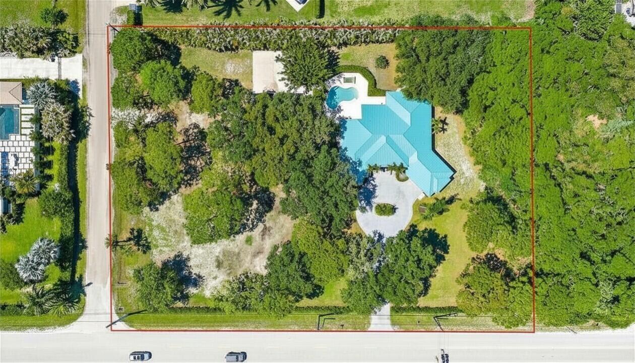 Perfectly situated in one of the most desirable locations in PBCE, this beautiful 1 story estate sits on 1.76 acres on a paved road and features a detached 528 sq ft cabana house/media room ideal for guests, a home office, gym, or theater. Built in 1998, this 4 bedroom, 3 bath home with a 2 car garage offers the perfect blend of luxury, privacy, and space for RVs, horses, and all your toys. Designed for both comfortable living and entertaining, the home features soaring 10 ft ceilings throughout, tray ceilings, a formal living room, spacious family room, and dedicated dining room. The kitchen is appointed with 42'' solid wood maple cabinetry with dovetail drawers, granite countertops, stainless steel appliances, a breakfast bar, and center island. Wood style tile flooring in a herringbone pattern adds warmth and elegance throughout the home. Other features include a large laundry room, city water, and 2022 metal roof.  Step outside to your private backyard retreat featuring an infinity edge saltwater pool and spa, covered patio, and expansive fenced grounds. The oversized primary suite features two walk in closets, dual sinks, a Roman tub, separate shower, and private water closet. This exceptional property combines luxury living with the ultimate country lifestyle in one of Palm Beach County's most sought after communities. Palm Beach Country Estates offers a rare non HOA acreage lifestyle ideal for horses, RVs, boats, and additional garages, with access to community parks, pickleball and basketball courts, trails, picnic areas, and convenient access to the Palm Beach Gardens Tennis & Pickleball Center. Just minutes from Jupiter/Juno beaches, Alton, Abacoa, premier dining, shopping, golf, I-95, and the Florida Turnpike.