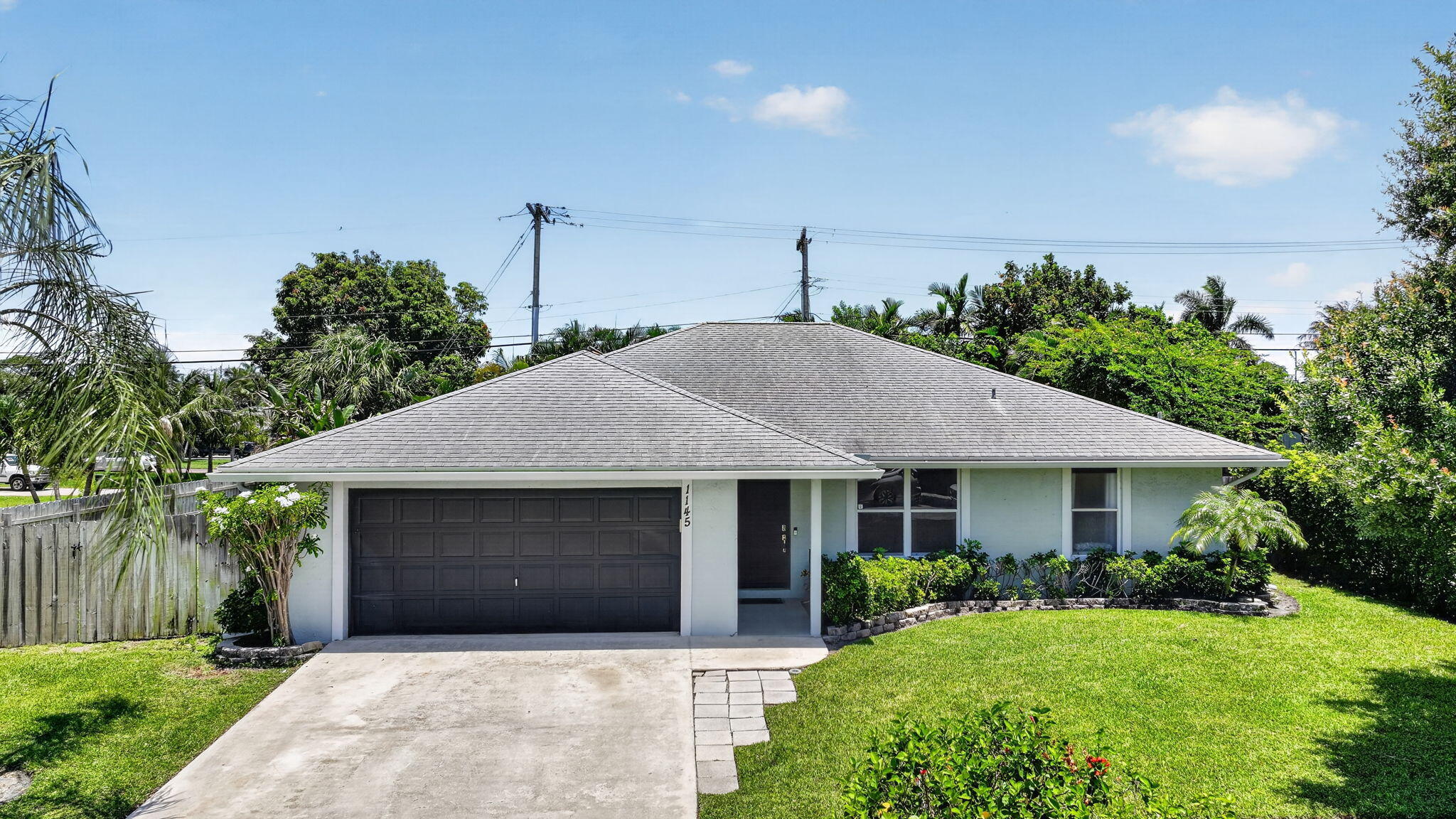 This highly desired corner lot, in a non- HOA community is located in the heart of Lantana and offers the ultimate dream of Florida style living. Just minutes from the beach, you can enjoy your own private oasis in your own backyard! The heated pool, screened in patio, tiki hut with a built-in bar and a built-in projector are perfect for all entertaining. Enjoy peace of mind with a brand-new 2026 AC compressor, a 2021 AC handler, and a 2016 water heater. Don't miss out on this amazing opportunity- schedule your private showing today and step into your very own tropical retreat! Garage Freezer, bar fridge, and table behind the outside bar do not convey.