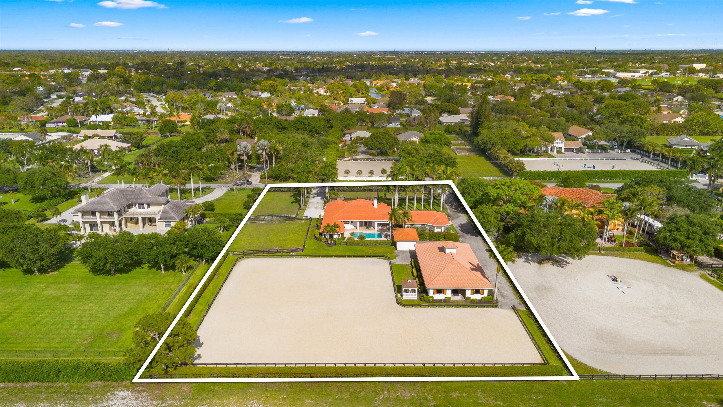 Exceptional equestrian facility located directly on the bridle path with access to Wellington's trail system and hacking distance to the showgrounds. Available for the 2026 season with a 3-month minimum and discounted rates for additional months .  The 8-stall center-aisle barn features spacious 12' x 12' stalls with fans, a whole-barn fly spray system, tack and feed rooms, covered wash and grooming stalls, shutters, and roll-down doors. Additional amenities include a new storage garage, covered manure pit, separate barn entrance, and a gazebo overlooking the arena.  The impressive 24,500-square-foot L-shaped arena (approximately 70' x 200' plus 85' x 123') was professionally built by Discount Dirtworks and offers exceptional drainage, providing outstanding footing for training and riding