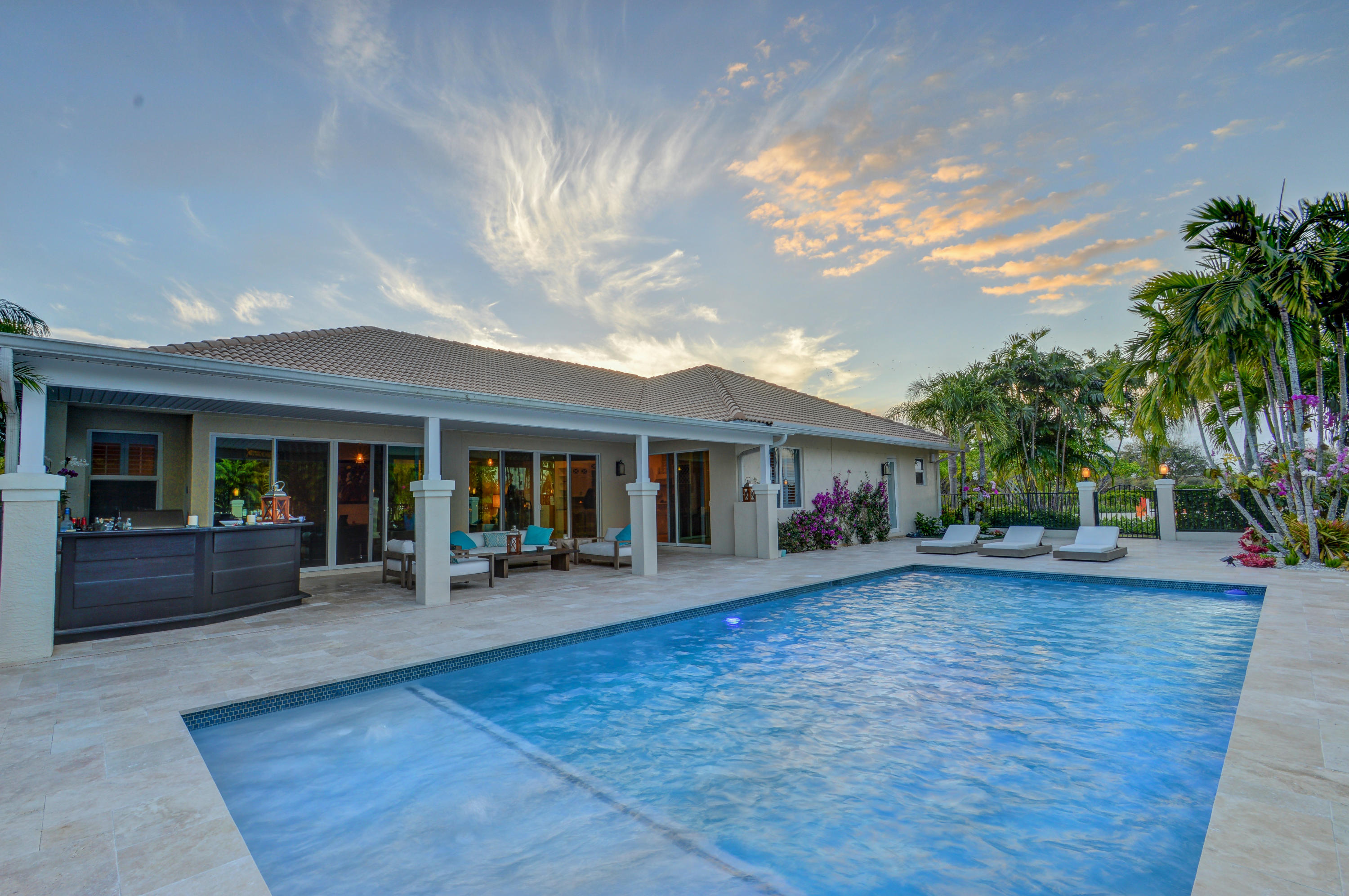 An ideal blend of rustic and transitional styles, this beautiful residence sits on 5.45 acres with a completely redone home features a split bedroom floor plan with sloped ceilings and decorative ledges that add interest to every room. The space boasts a formal dining area and eat-in kitchen, with Carrara marble countertops and stainless steel appliances. In the master bedroom, separate shower, dual sinks, and a sitting area are standout attributes. 
Outside, the covered French travertine patio, outdoor kitchen and heated saltwater pool look onto the 8 stall center aisle barn. The property also features a 135'x230' riding arena with all-weather sand textile mix and surround sound, a grass riding area, and 7 paddocks. A short hack away from show grounds, this estate will delight any equestrian. Site work has been done and plans are approved to renovate the 8 stall barn to 12 stalls with two additional wash stalls and staff apartment.