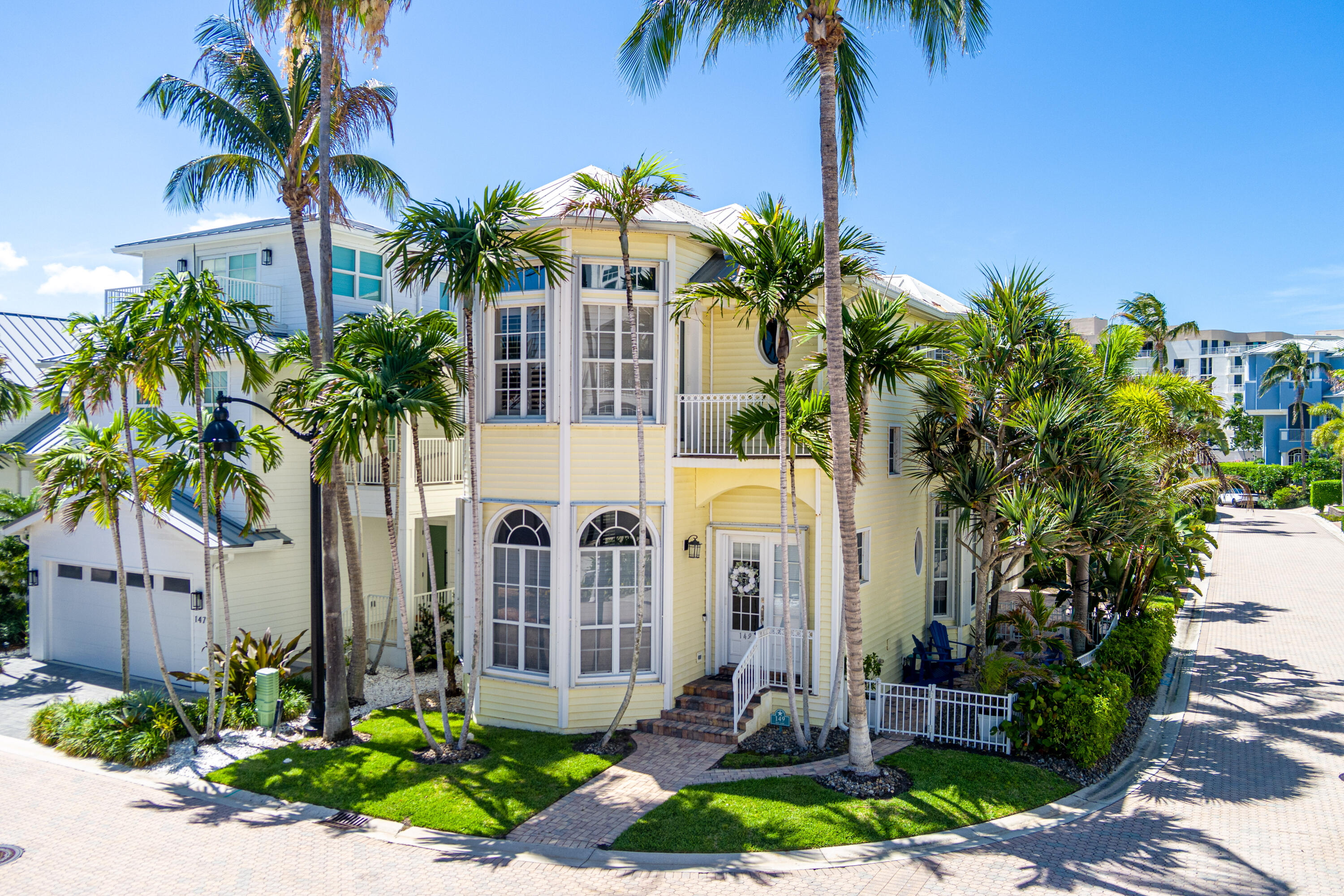 Located in the gated Jupiter Key community just steps from the beach, this stunning 2-story coastal home offers 3 bedrooms, 2.5 baths, and luxury finishes throughout. The first floor features an expansive kitchen with dining and sitting areas, built-ins, beverage station, oversized granite island, and induction cooktop range, flowing into a bright cheery living room with arched windows and plantation shutters. Upstairs, the spacious primary suite offers a sitting area, ocean glimpse from the sliding doors, walk-in closets, and spa-like bath with separate shower and soaking tub. Guest room with Murphy bed doubles as an office. Additional features include a 2-car garage with split A/C, outdoor shower, private patios, and close proximity to the community pool, beach, dining, and shopping.