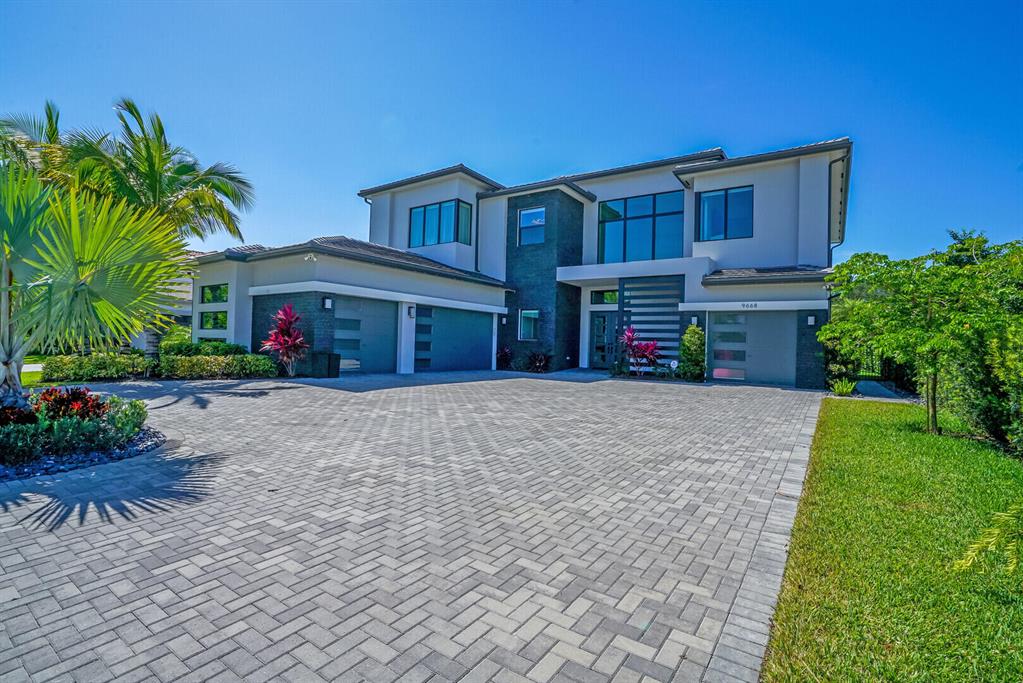 This Palermo Model home is truly exceptional, boasting luxurious finishes throughout. It is ideally situated at the end of a street next to a cul-de-sac, with a circular driveway that provides a welcoming entrance. With over 6,175 square feet of living space, this stunning property comprises 5 bedrooms, 6 full and 1 half baths, an office with custom built-in bookshelves, an amazing media room, and an oversized bar in the formal living room with a breathtaking custom wine wall, all with stunning views of the pool. The chef's island kitchen is beautifully designed with 2 oversized islands, quartz countertops, and top-of-the-line Wolf and Sub Zero appliances, along with a large walk-in pantry. The kitchen flows seamlessly into the spacious family room, breakfast area, and cabana bath. The family room boasts a stunning wall of glass doors that open up to the covered lanai, complete with a motorized pergola and summer kitchen. Here, you'll find everything you need for outdoor entertaining, including a gas grill, Green Egg, fridge, ice maker, and kegerator. The space is filled with natural light and fresh air, creating a seamless indoor-outdoor flow. The magnificent primary suite is equally impressive, featuring a large wraparound balcony that overlooks the pool, 2 custom walk-in closets, and a stunning primary bath with a soaking tub. Additionally, there are 4 more bedrooms, each with its own private bath and custom closets, providing ample space for family and guests alike.