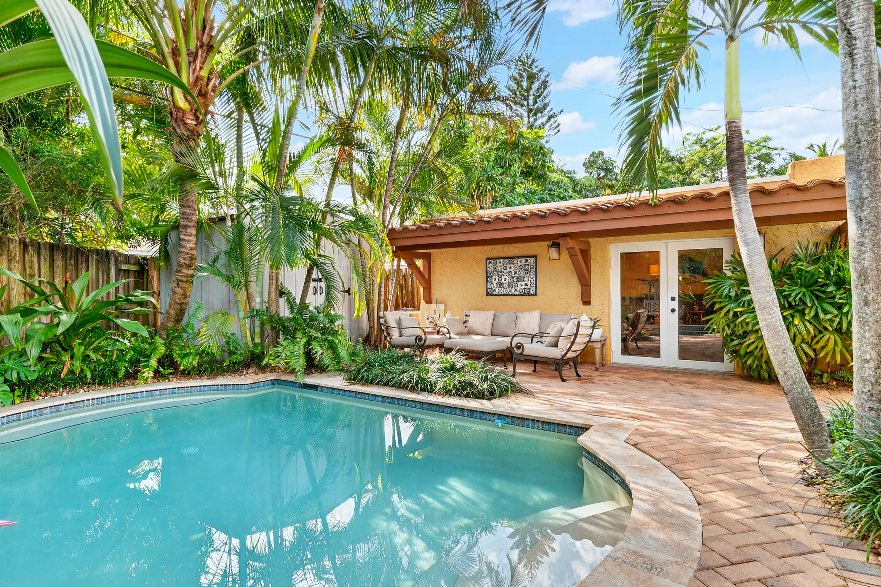 Welcome to 348 Plymouth Road!  This home is a rare opportunity to own one of the finest and most authentic Mediterranean Revival properties in the Belaire Historic District. It is ideally located in the highly desirable locale of SoSo in West Palm Beach. This unique home offers unbeatable access to downtown West Palm Beach, Palm Beach International Airport, Antique Row, Worth Avenue, I-95, South Olive Tennis Center, and SoSo's growing collection of restaurants and boutiques.  Set in tropical landscaping, this thoughtfully restored residence honors its architectural heritage while offering modern amenities for today's lifestyle. Seller has contract in place for new roof and will hold back money in escrow if not completed prior to closing.  Main house tented for termites, May 2026 with transferable bond.  Guest Cottage Water Heater brand new, May 2026. Primary bedroom AC brand new, May 2026.  Complete PVC plumbing throughout entire house and guest house all the way into street. The main house offers three bedrooms and two full bathrooms, with a private primary retreat that is separated from the main living area, allowing exceptional privacy and space. The primary retreat features a dressing room and its own outdoor patio that is perfect for quiet mornings or relaxed evenings. The ensuite bathroom has a view to the tropical gardens surrounding the pool. Original details have been carefully preserved and updated, including beautifully refinished Dade County pine floors and pecky cypress ceilings and beams, which create warmth and authenticity throughout the home. The bedroom closets are unusual for the homes era given their large size. New 2020 roofs and impact-resistant window film on all original windows provide added peace of mind without sacrificing original architectural details. The kitchen is in a Mediterranean style, as well. It has all the amenities for a chef, such as plenty of prep and storage space, a gas range, and pantry, all of which is ideal for both everyday cooking as well as entertaining. The charming cottage is equipped with a full three-piece bathroom, kitchenette, large closet, and central HVAC that is ideal for hosting guests, creating a home office, or accommodating multigenerational living. The tropical backyard is designed for entertaining and relaxation featuring a pool, covered lounge area, pergola-covered dining area, and ample patio space. Combined with the cottage, it is suitable for gatherings of up to 50 guests. Main House = 1,507 sq ft and guest house = 391 sq ft.