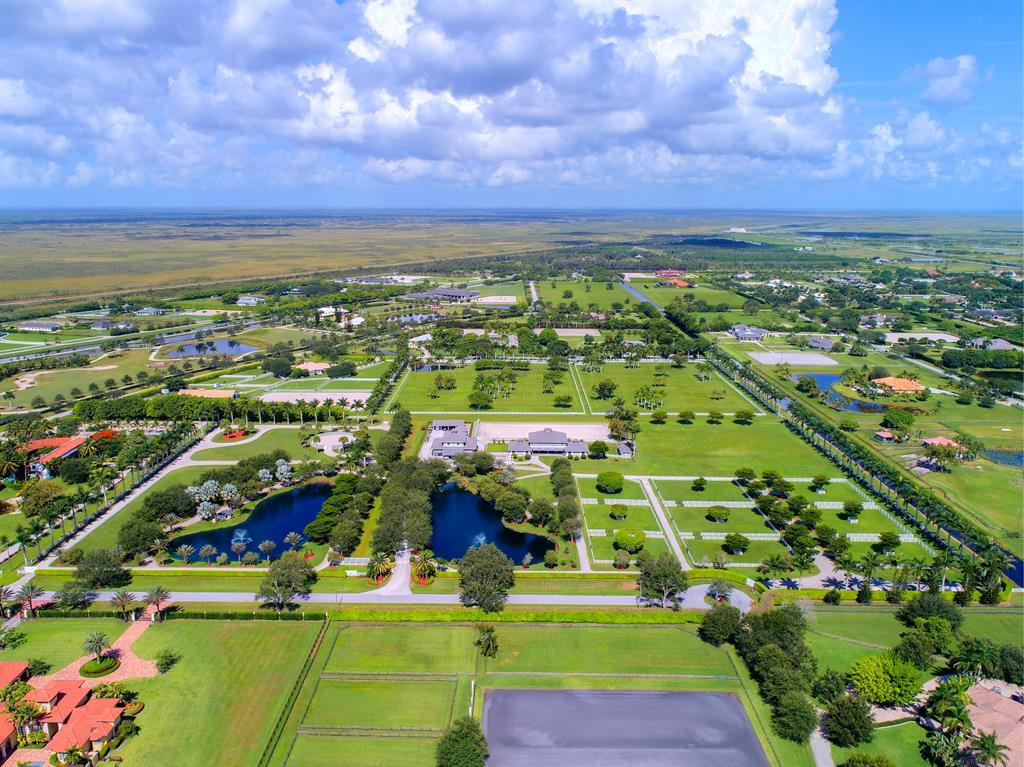 This stunning 27 acre Palm Beach Point gated equestrian compound is being offered for the first time in nearly 20 years. Located in the heart of Wellington it is only minutes to the Winter Equestrian Festival, Global Dressage Festival and the International Polo Club. Comprised of five (5) separate lots with frontage on two (2) paved roads this property has many possibilities for both the equestrian and investor. This is the largest property available in Palm Beach Point offering the discerning buyer privacy, options and incredible value. Truly a Must See property!!