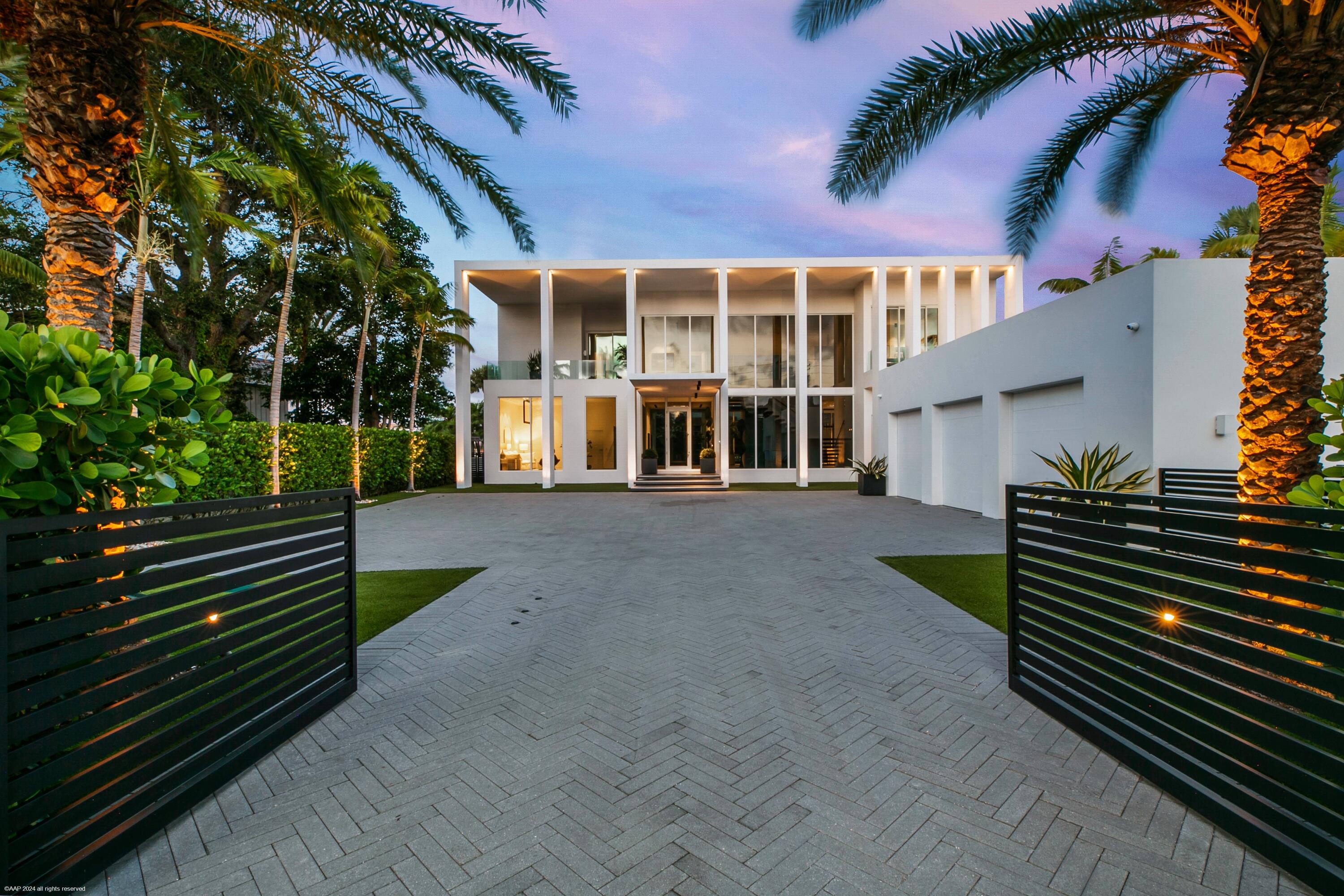 Nestled in prestigious Palm Beach Gardens, this stunning single-family home epitomizes luxury living with its gorgeous water views and ultra-modern design. Boasting a prime location, every aspect of this residence exudes elegance and comfort.Upon entering, you are greeted by an expansive foyer that leads seamlessly into the spacious living areas. The interiors are adorned with high-end finishes, including large format tile floors, custom Bizassa tiled bathrooms, designer light fixtures, and soaring windows and glass doors, creating an ambiance of sophistication with unobstructed views. The gourmet kitchen is a chef's dream, featuring state-of-the-art appliances, sleek cabinetry, and a center island perfect for culinary creations or casual gatherings. Adjacent, the dining area offers panoramic views of the waterfront, setting the stage for memorable meals with family and friends.
The primary suite is a sanctuary of relaxation, complete with an expansive private terrace overlooking the serene waterways, a luxurious European designed en-suite bathroom with a generous soaking tub, grand walk-in shower with rain showerhead, dual vanities, and ample closet space for ultimate convenience.
Outside, the expansive lanai and inviting pool area provide an ideal setting for outdoor living and entertainment. Enjoy breathtaking views from the infinity-edge pool, host a family BBQ at the outdoor summer kitchen with seamless access to the interior kitchen, or unwind at the firepit table while soaking in the picturesque surroundings.
The VIP guest suite, or second primary bedroom, is generously spacious, featuring a layout that exudes both privacy and openness. The floor to ceiling windows and sliding glass doors allows for panoramic views of the waterway and offer an enormous amount of natural light with direct access to the private covered lanai. Boasting a spa-like European style en-suite bathroom, spacious walk-in shower with rainfall showerhead, dual vanities with ample counter space and storage cabinets are seamlessly integrated into the design. The thoughtfully designed walk-in closet can accommodate both short-term and long-term stays. It features custom shelving, drawers, and hanging space for clothing and personal items, ensuring guests feel at home during their stay.
Additional highlights of this exclusive residence include a private deck for basking in the South Florida warmth, a wine cellar for connoisseurs, a media room for cozy movie nights, state-of-the-art home technology with built in sound system- all controlled from the convenience of your ipad or cell phone, a meticulously kept oversized 3-car garage that is climate controlled and features sufficient storage. Fragrant herbs flourish in the personal herb garden at the front of the estate.
Located in one of South Florida's most coveted areas, you will enjoy easy access to fine dining, shopping, and entertainment options, as well as proximity to pristine beaches and world-class golf courses.