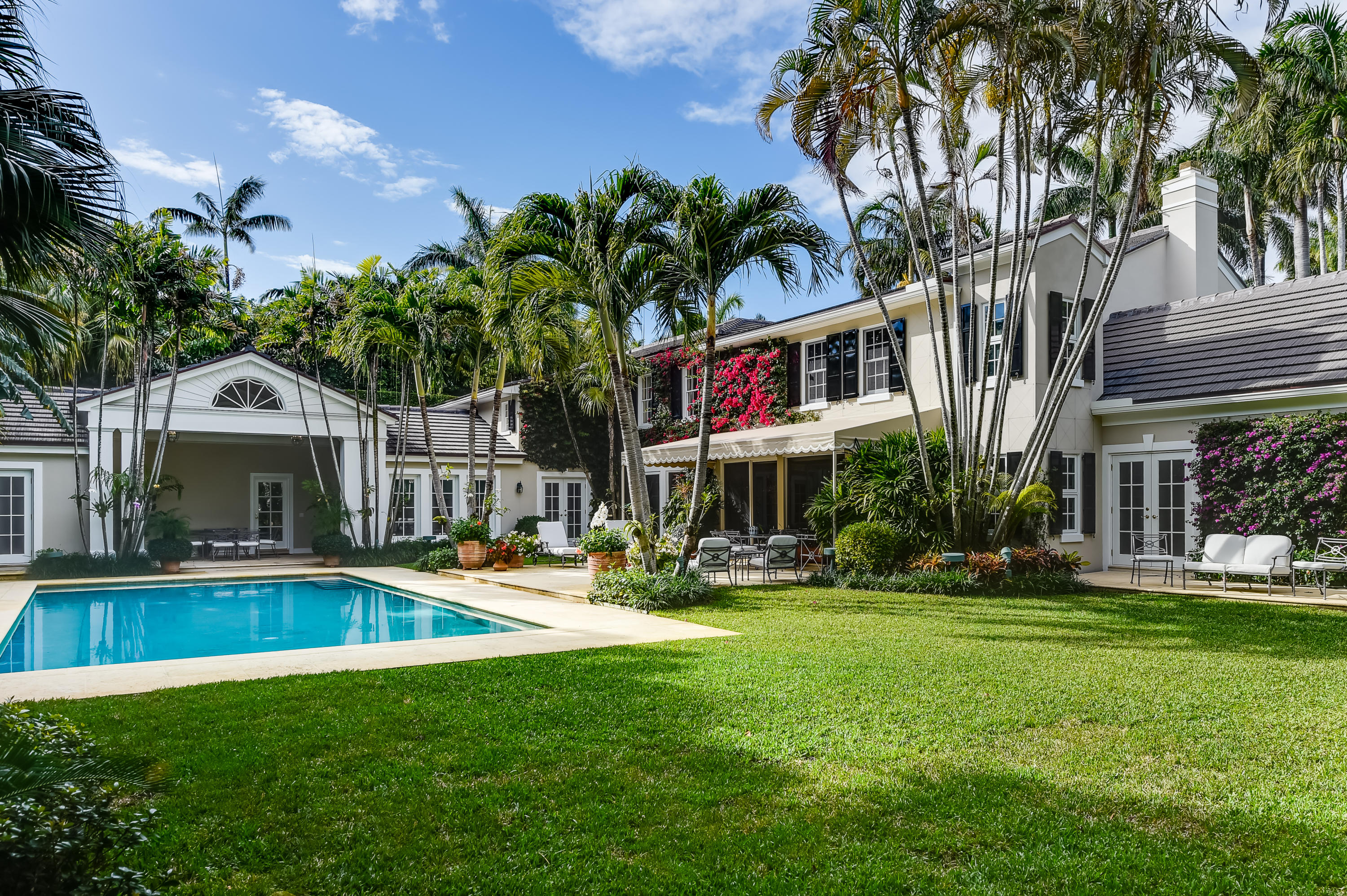 Sited on one of the prettiest streets in Palm Beach, this elegant traditional residence embodies the perfect home to enjoy a Palm Beach lifestyle. There is a seamless flow from the indoor spaces to the lush outdoor spaces. This 4 bedroom, 5.5 bath home is private and secluded. Enter into a large foyer with a dramatic staircase, flowing into to a formal living room with a fireplace.

There is an adjoining sun-filled family room with a cathedral ceiling and French doors opening to the garden. The large master suite is a refuge with its own private sitting room. The generous sized rooms also include a cozy paneled library/office, formal dining room with bay window, and breakfast room. The loggia overlooks a large pool and two covered outdoor dining areas. The large lot is 140 x 165. This stunning residence is completed by a full house generator, 2 car garage, and elevator. Located in the Estate Section, this classic Palm Beach residence has been meticulously maintained.