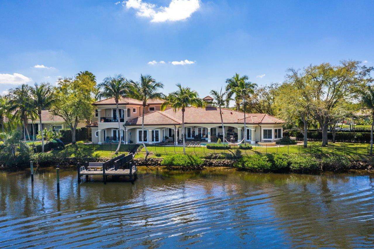 18669 SE Palm Island Lane. Boaters paradise with a dock incl. 16K lb. lift & 2nd dock, both with ocean access! Impressive waterfront home in Jupiter River Estates (AKA Islands of Jupiter). Just a short drive to Jupiter Beach, Juno Beach Park and the shops, restaurants & nightlife of Harborside. Custom-built, spacious layout with 5 bedrooms, 5 full baths, pool and 3-car garage. This expansive property situated on over ½ acre lot has multiple indoor and outdoor spaces to retreat to. Designer kitchen with top of the line appliances, butler's pantry, game room with bar, exercise room. High ceilings, beautiful marble flooring, impact glass throughout and amazing river waterfront views! Separate living space with full kitchen on the 2nd floor provides flexibility for in-laws, guests or nanny Enjoy water views while relaxing on the patio with heated pool. Providing 2 docks, a boat lift and approx. 280 ft. of water frontage on front and back of house, you'll be living the South Florida lifestyle you've been dreaming of.
