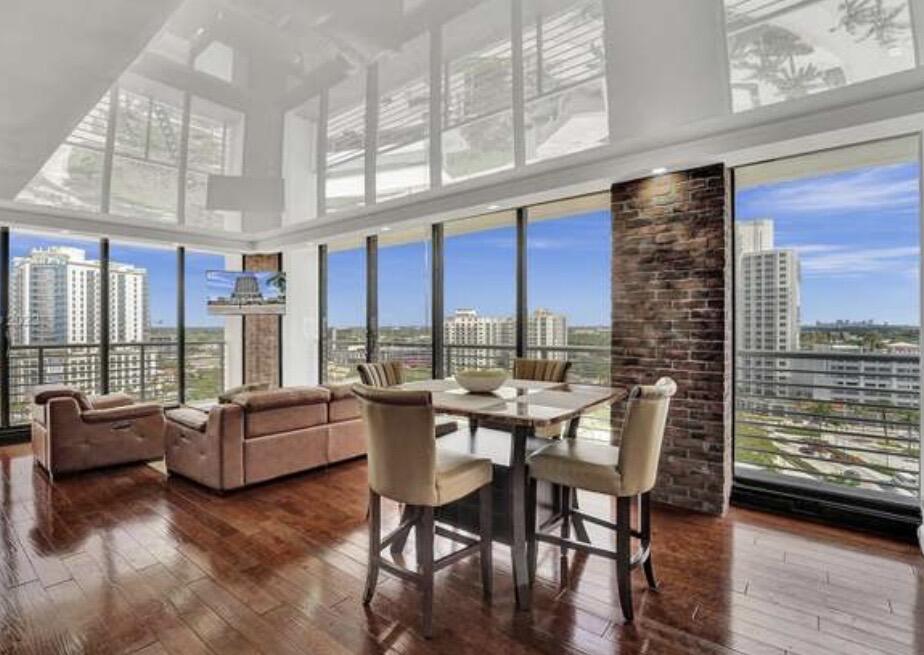 Welcome to this beautifully updated corner residence in the heart of Downtown Hollywood, offering breathtaking panoramic city views from the 14th floor. This light-filled unit features an open-concept layout, updated finishes, wood flooring, and the convenience of an in-unit washer and dryer. Located in a sought-after building that allows short-term rentals, this property presents an exceptional opportunity for investors, seasonal owners, or those seeking flexible rental income potential. Residents enjoy resort-style amenities including a swimming pool, fitness center, secured entry, and on-site management. Ideally situated just minutes from Hollywood Beach, the Boardwalk, restaurants, entertainment, shopping, Gulfstream Park, Aventura Mall, and Fort Lauderdale-Hollywood Airport.  Can be sold Furnished.