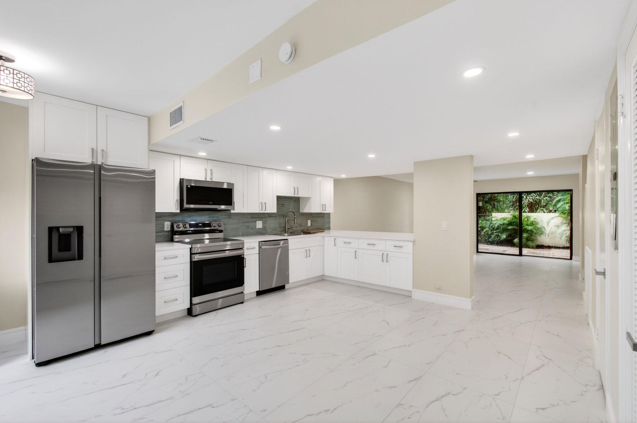 Rarely available in this sought-after Boca Raton community—and now's your chance! This newly renovated two-story townhome shows like a model. The light-filled kitchen stuns with waterfall quartz counters, white shaker cabinetry, and stainless appliances, flowing into an open living space framed by gorgeous tile (no carpet anywhere). Both en-suite bedrooms sit upstairs: the primary boasts a double-sink vanity, smart mirror, and private balcony; the second offers a built-in window seat. Every shower pairs a rainfall head with a handheld, and all 3 baths feature bidet toilets. Smart touches abound—Ring doorbell, keyless entry, upstairs stackable W/D, and abundant closets including under-stair storage. AC '26, water heater '25. Near Town Center, Whole Foods, Baptist Health & FAU!