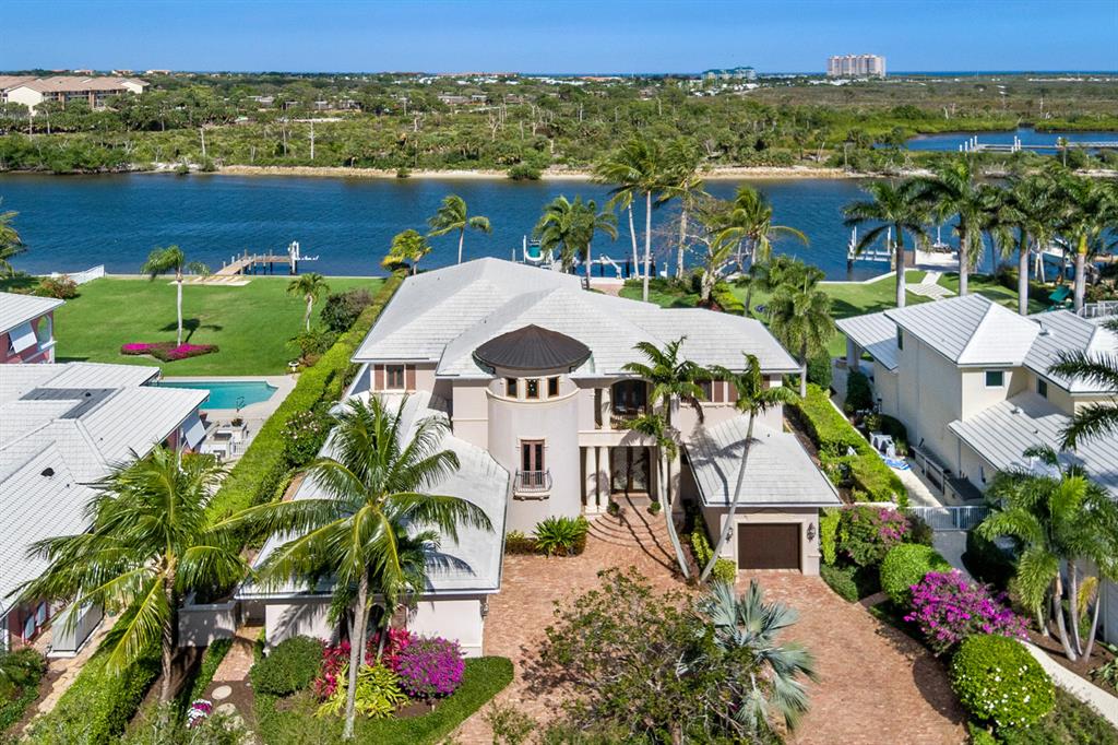 Luxury Abounds with this Exquisite Direct Intracoastal Waterway Estate situated on nearly an acre of lush landscaped grounds in the exclusive Cypress Island Yacht Club Community! Serenity awaits as you enter this exceptionally timeless custom-built home with marbled foyer and living room showcasing panoramic views of the waterway. Built-in bar, formal dining, breakfast nook and large family room make this home the ultimate for entertaining. Creatively planned gourmet chef's kitchen provides 6 burner gas cooktop, warming drawer, 2 new ovens, 2 dishwashers, large island with sink, newer appliances and a large pantry. Perfection in detail throughout the home with luxury finishes in the 2 master suites (featuring his and her bathrooms and closets for primary bedroom), Upstairs fitness area, 2 built-in offices, 2 additional guest bedrooms, 5 full bathrooms and 2 half baths, 3 car garage and complete storm protection. Expansive balconies with Pecky Cypress ceiling offer spectacular views! Newly built 100-year seawall and 50-year dock, complete with a boatlift, electric, plumbing and LED dock lighting, with 100 feet of water frontage along intracoastal waterway. Private putting green with sand trap, pristinely maintained heated pool & spa. 180-gallon saltwater living coral reef aquarium, summer kitchen, full-house (65 kw) Kohler Generator.