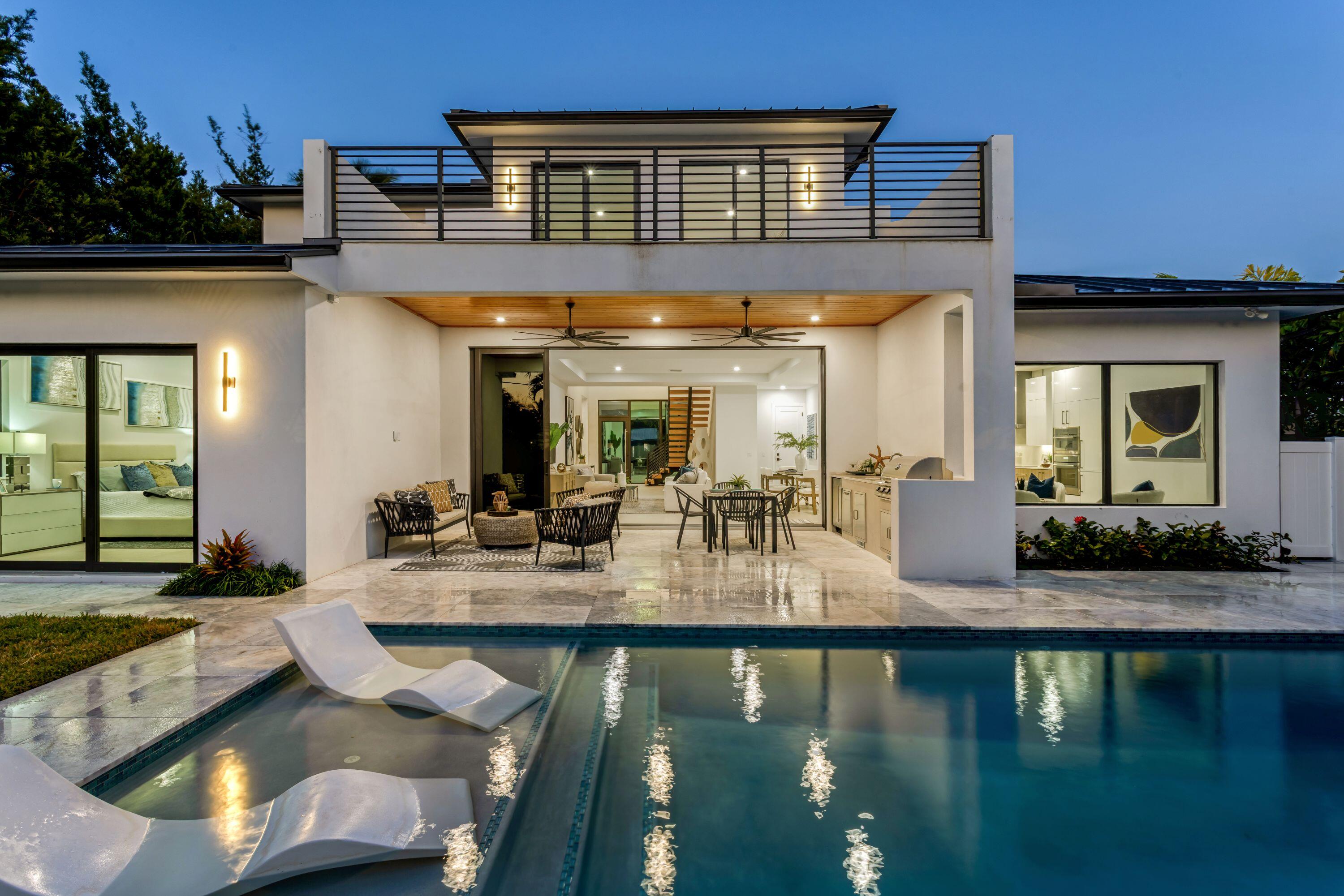 This brand-new coastal-contemporary is designed for ease of living and highlighted by luxury finishes and move in ready! The feel is light, bright and breezy with a fresh, modern 'Now' vibe. Topped by a soaring 21-foot-high ceiling, the grand foyer, with a dramatic floating staircase, sets a sophisticated tone. Radiating effortless elegance, the adjoining principal rooms are organized in an open-concept layout with 10-foot ceilings, a neutral white color palette and 48'' x48'' large-format tile flooring. Open to the living and dining areas, the kitchen is centered on a cook's island and fitted with warm wood cabinets contrasted by clean, white uppers, quartz countertops, and premium Thermadore appliances including a wine cooler. Sliding glass doors in the living room to the loggia fully pocket away, visually and functionally amplifying the sense of space. With 5,053± total square feet and five bedrooms in a split-bedroom plan, the primary suite, a serene retreat, is situated on the first floor. The suite, topped by a coved, backlit ceiling and featuring sliding doors to the pool area, comprises two custom-fitted walk-in closets and a spa-like bathroom with custom double vanities topped by solid-surface integrated sinks, backlit mirrors, expansive double-sized glass-enclosed shower with two shower heads, a freestanding soaking tub and a separate toilet room. Also on this level are a laundry room, a flexible guest-bedroom suite/office and two-car garage. Upstairs, serving three guest bedrooms, all with their own private en-suite baths, is the loft living area with sliding glass doors to the pool-view balcony. For added convenience is an additional laundry on the 2nd floor. Amenities include remote-controlled, fog-out/privacy film for the front-entry glass, impact windows and doors and metal roof. This luxe newly built residence is ready for immediate occupancy. Welcome to your dream home in the coveted Lake Ida neighborhood!

LOCATION: 

1408 Pine Lane, Delray Beach, Florida: Lush green parklands and scenic picnic areas are only part of Lake Ida's appeal. This coveted neighborhood also enjoys easy access to canoeing, kayaking, freshwater fishing; the highly acclaimed Delray Beach Playhouse; Delray Beach's historic downtown district, with an array of boutiques and bistros along vibrant Atlantic Avenue; and pristine Atlantic Ocean beaches just minutes away. 

PROPERTY: 
 
In the fenced backyard, the loggia, topped by a tongue-and-groove wood ceiling and featuring a fully equipped summer kitchen, flows out to the saltwater pool with a sun shelf inviting outdoor entertaining and relaxed leisure time. Additionally, the outdoor shower is convenient when returning from the beach.
