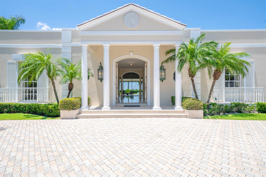 Fabulous updated Regency style home with private, elevated views of the Intracoastal. More than 1/2 acre of land with 100' waterfront. New deep water dock and sea wall. First floor Master. New appliances and flooring. Beautiful newly refinished pool/spa entertaining area. Possibility exists to add additional second floor square footage. Decorator Ready.