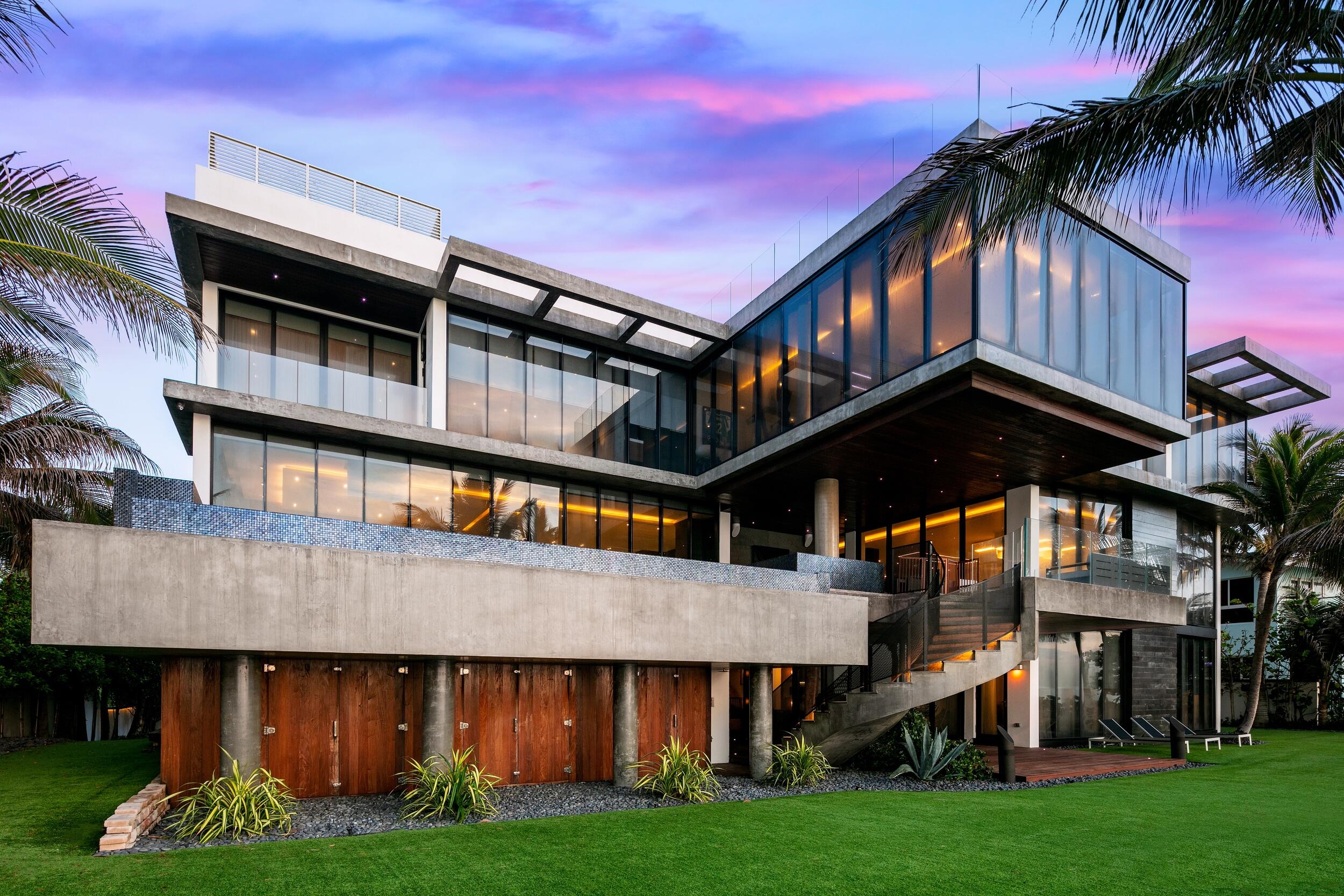 This brilliantly conceived masterpiece set along the shores of the prestigious Highland Beach is a true original with a mix of artistic flair and resort-style splendor. 
Built 17 feet above sea level, the four-floor marvel, encompassing more than 11,300 square feet of interior spaces alone, boasts seven bedrooms and nine baths. A thoughtful architectural touch—the brise-soleil effect that reduces heat absorption by deflecting sunlight—sets the tone for the innovative details and contemporary sophistication that elevates the indoor design. 
Floor-to-ceiling windows frame views of the Atlantic Ocean in each of the living spaces, adding unencumbered comfort to the chic, open layout. Interior highlights include a living greenery wall; a designer kitchen and separate catering kitchen; a nearly 1,200-bottle wine wall; lava stone walls and floors; a theater/screening room; and a third-level master wing with a sitting room, a bath that recalls a luxury spa, an epic closet, a separate exercise room, and an office/study overlooking the Atlantic. 
The second-story outdoor setting, a paradise unto itself, boasts a summer kitchen and grilling station, as well as an infinity-edge pool, whirlpool bath, and lounge area. Better yet, the sprawling property fronts more than 120 feet of pristine, private beachfront and a mammoth 3,000 square feet sky deck for entertaining large groups. 
Experience breathtaking oceanfront tranquility.