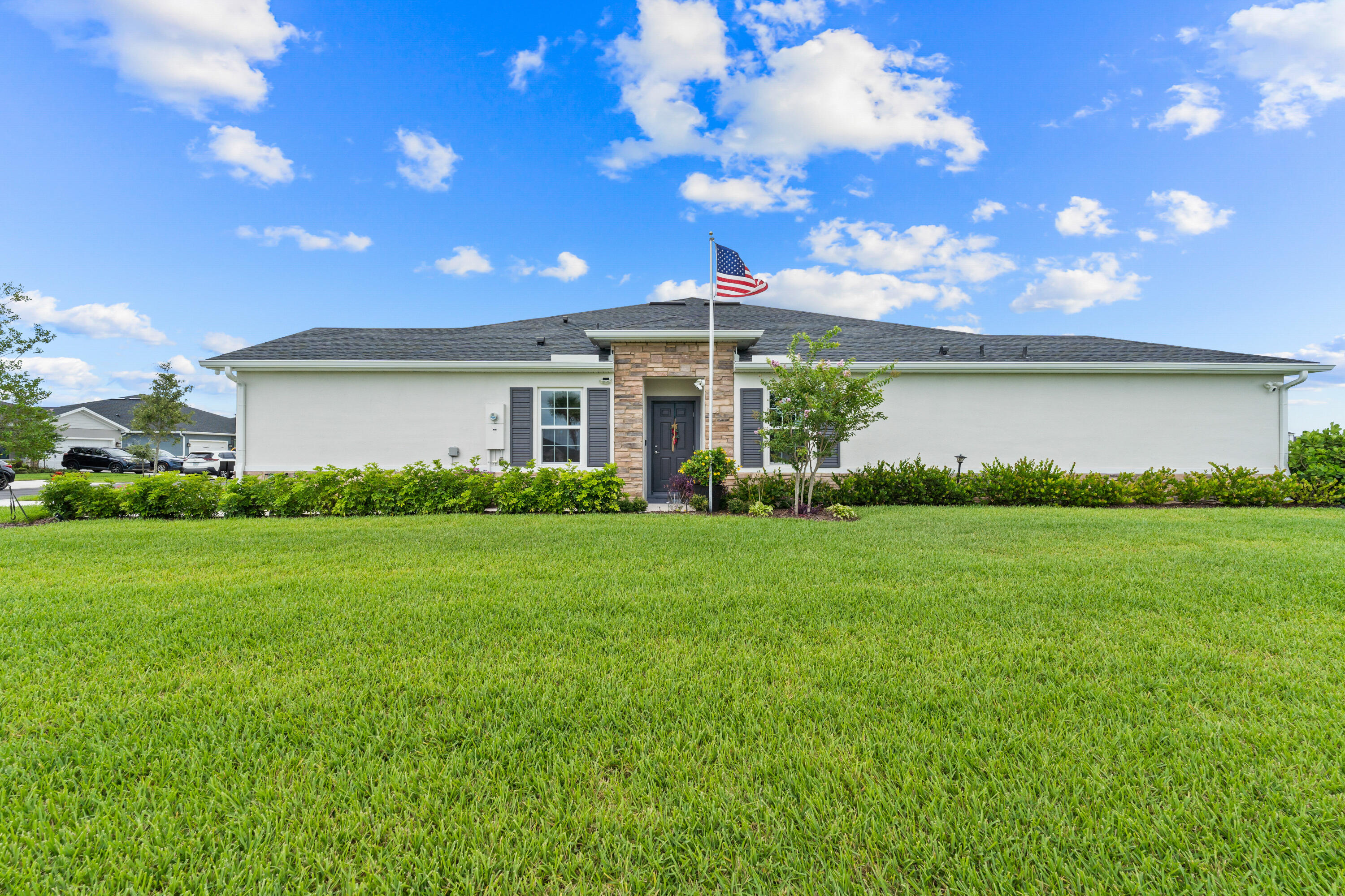 Only two years old and impeccably maintained, this spacious Ryan Homes residence offers the perfect combination of modern elegance, thoughtful upgrades, and an outstanding location just minutes from Tradition, I-95, premier shopping, dining, entertainment, and medical facilities. Nestled on a premium corner homesite with no immediate neighbor on one side, this property provides an enhanced sense of privacy and space that is increasingly difficult to find. Designed with both beauty and functionality in mind, the home showcases impact-resistant windows throughout, upgraded cabinetry, a large walk-in pantry, and a light-filled open-concept layout ideal for everyday living and entertaining. Outdoor living is equally impressive, featuring the screened lanai plus an extended patio that   significantly expands the outdoor entertaining and relaxation space. Whether hosting family gatherings, grilling with friends, or enjoying a quiet evening outdoors, this thoughtfully designed backyard offers flexibility and comfort. Additional enhancements include a side privacy fence, decorative trellis enclosure for discreet storage of recycling containers, and an epoxy-finished garage floor that adds both durability and sophistication. The generously sized corner lot offers extra privacy and open space rarely available in newer communities. Residents enjoy a low quarterly HOA fee of only $393, which includes landscaping and irrigation, along with access to outstanding community amenities including a resort-style swimming pool, tennis courts, playground, and beautifully maintained common areas. Combining nearly new construction, premium upgrades, elegant finishes, low-maintenance living, and a highly desirable location, this remarkable home presents an exceptional opportunity to enjoy the very best of the Port St. Lucie lifestyle.