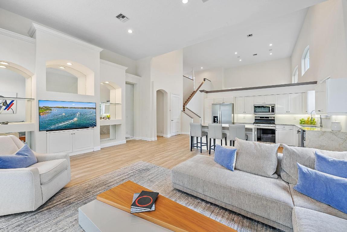 Located just 500 feet from the world-class amenities of the Club at Ibis, this conveniently located and renovated home boasts incredible water views and a spacious floor plan. Boasting more than 2900 square feet, this immaculate 3BR/3.5BA+Den+Loft  home offers all ensuite bedrooms, soaring ceilings, and over-sized rooms. The SOUTHERN EXPOSURE in the rear of this home, bathes the pool in light, and allows for sunlight to enter the many windows, offering a bright feel. This home was renovated in 2021, with all-new flooring on the main level, new kitchen appliances, new HVAC, and the interior was painted. New quartz kitchen counter-tops and backsplash, new glossy white upper kitchen cabinets, replaced faucets, new lighting, door and cabinet handles, trim and throughout the property. The heated pool's pump was replaced in 2024. The Club at Ibis is an award-winning community that boasts a 90,000 sq. ft. clubhouse, three 18-hole Nicklaus-family Championship golf courses, five restaurants, a world-class fitness complex and spa, and incredible tennis and pickleball facility.