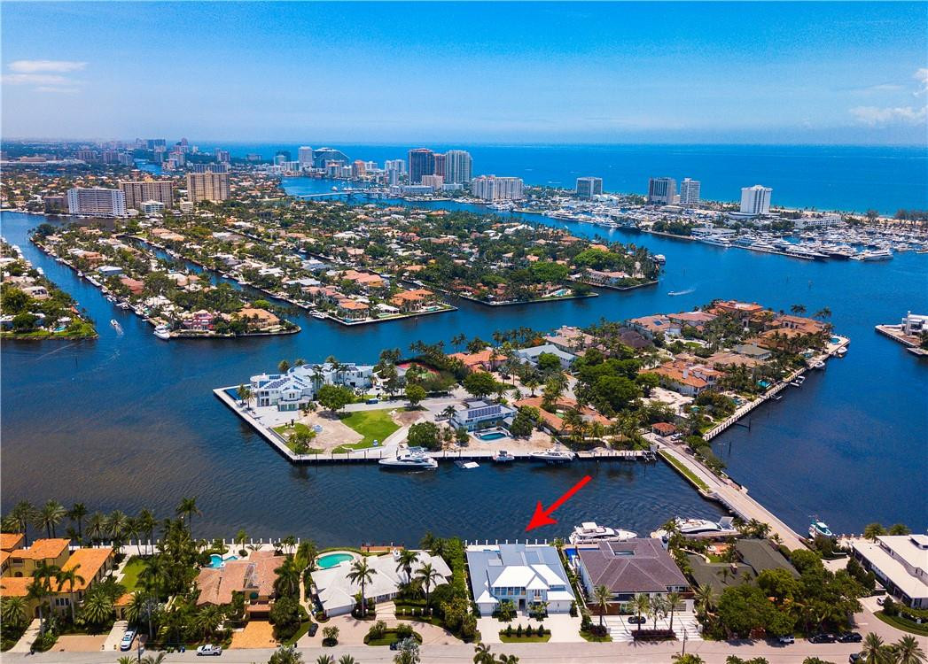 Brand new Coastal Modern direct intracoastal residence offers the most amazing open views from one of Harbor Beach's finest & most valuable isles! Timeless design offers a highly welcoming appeal! The elegant island ambiance & soft blue-grey interiors create a beautiful living environment flows seamlessly from indoor to outdoor entertaining areas. Open great room features fireplace, custom stone/hardwood flooring, elegant formal dining room & crisp white kitchen open to breakfast area. All open to impressively large poolside loggia, outdoor living room fireplace & Summer Kitchen. Expansive downstairs Master Suite, library - second level VIP Guest Suite & two additional bedroom suites, 5th bedroom currently used as Den. Architect Stofft/Builder Sarkela guarantees a high quality offering.