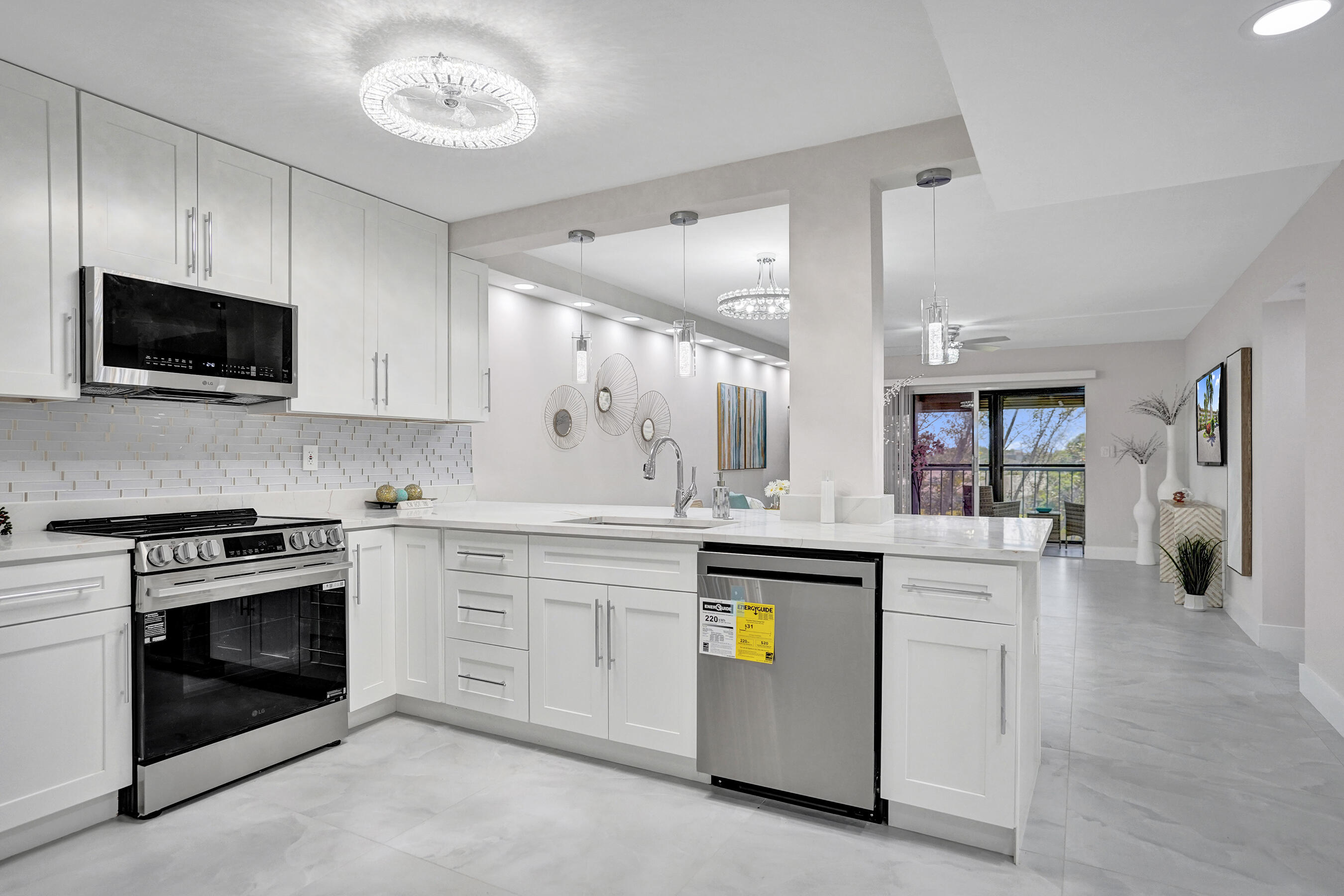 Welcome to paradise!  Stunning 2 Bed / 2 Bath RENOVATED Condo - Huntington Lakes, Delray Beach.  This beautifully renovated condo in the desirable and active 55+ community Huntington Lakes is filled with natural light and an uplifting vibe throughout.  35 in MATTE PORCELAIN tiles through entire condo.  Spacious kitchen with large stainless sink and energy-efficient appliances. Primary bedroom features two walk-in closets plus ample storage throughout Beautiful fan lights add style and comfort.  Long, screened, glass-enclosed balcony with stunning views of TWO LAKES.  Pull down storm shutters.  No neighbors above — private, and peaceful.    Close to Atlantic Avenue for shopping, dining, beach, and entertainment.  Simply move and and enjoy...