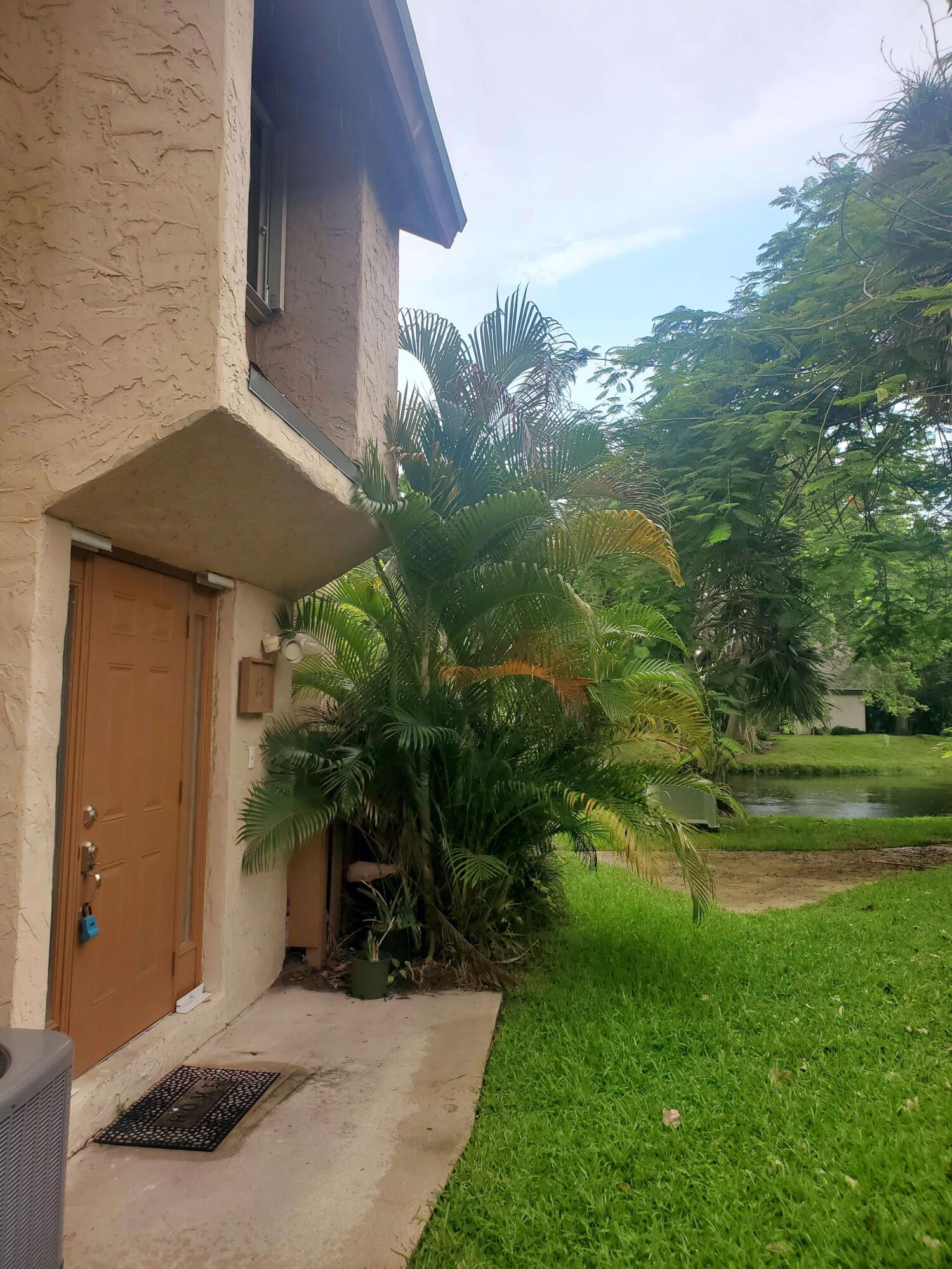 Spacious lakeside retreat condo located in the heart of Plantation. This upgraded 3 bedroom, 2 bathroom 2nd floor corner unit offers peaceful water views from the 2nd floor balcony. Condo features an open floor plan with renovated kitchen with granite countertops, stainless steel appliances, newer refrigerator, and upgraded cabinetry. New vanity in Master bathroom, and new lighting and mirror in both bathrooms. Newer stackable washer/dryer in unit, freshly painted with tile flooring and 6" baseboards throughout. Brand new roof installed in 2024, newer AC installed in 2021. Accordion hurricane shutters for all openings. This family, pet, and age friendly community has an association pool and tennis court with lots of green space, and TWO assigned parking spaces!  Located near Plantation Central Park and minutes from shopping, dining, and malls. Monthly HOA fees $486 and 2-year lease restriction