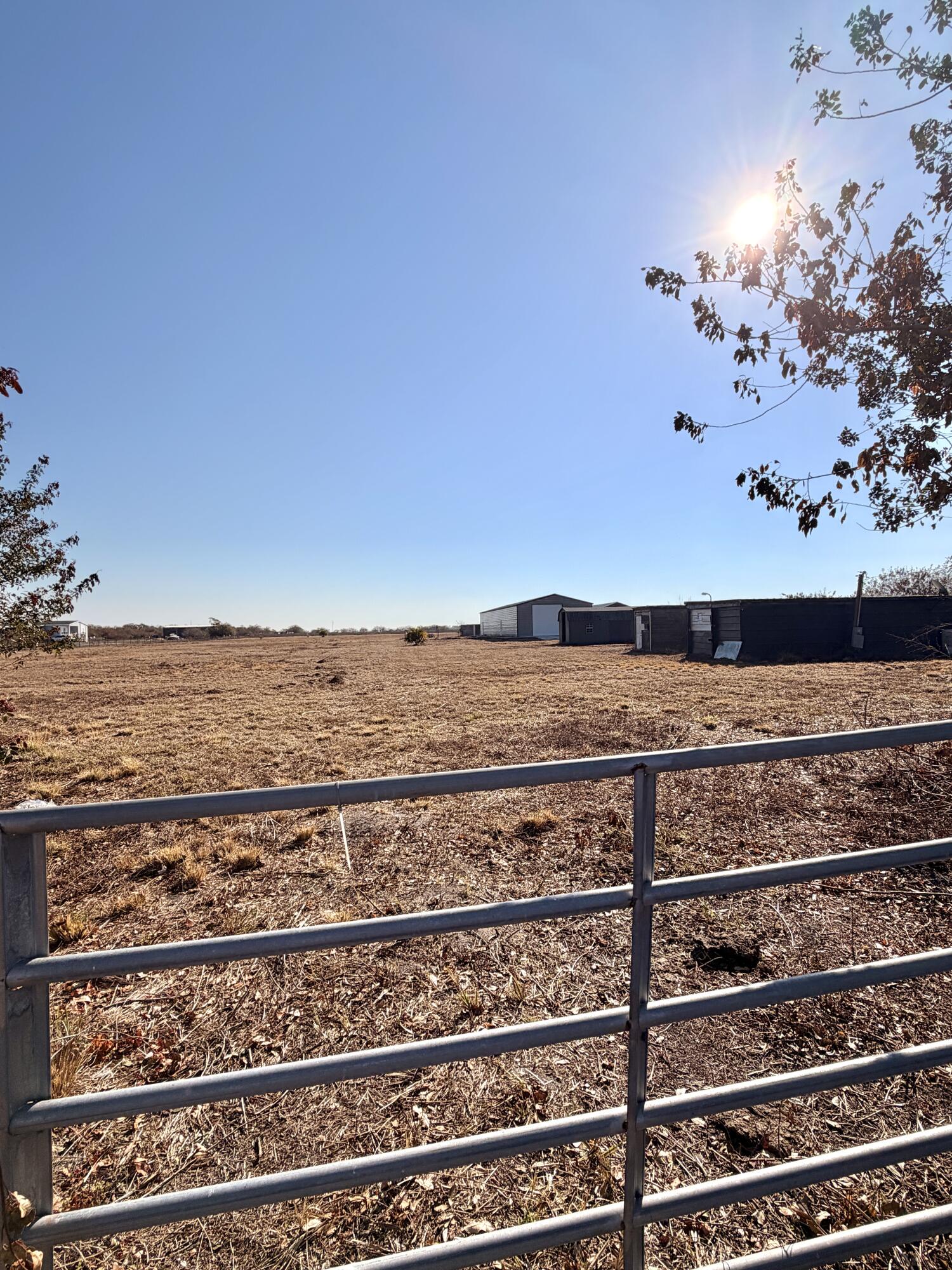 10 acres of cleared land featuring a large metal workshop with electric, two sheds, and two storage containers. Property includes a well and electric already in place, offering a strong head start for building, business use, or storage. Versatile acreage with endless potential. Fenced and gated.