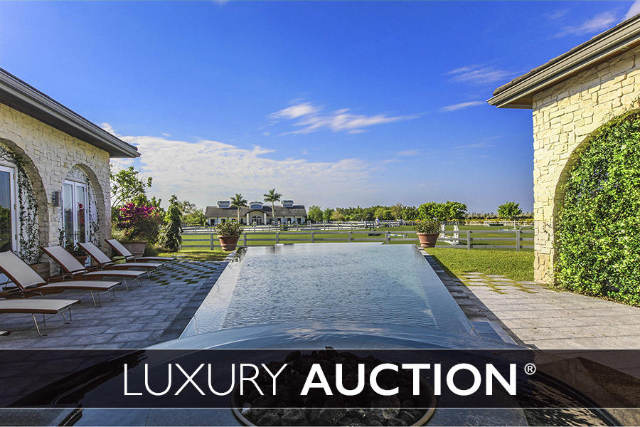 This elegant equestrian estate will be sold at Luxury AUCTION on February 25, 2017! Selling at or above a Reserve price of only $4 Million! List price used here is FOR REFERENCE ONLY. Inquire for complete auction details.
This stunning 10 acre equestrian estate in private gated enclave.  Designed with an eye for detail and tranquility, the property offers a 4Br/4Ba main residence, 2Br/2Ba managers home with two additional staff apartments, totaling 4 bedrooms. The equine amenities offered are a 12 stall stable, jumping arena, grass grand prix or hunter field & large turnouts with plenty of room for a covered riding arena.  The infinity edge pool, yoga & Pilates studio along with flow of this home offers a Zen quality never been seen before This is a green property with Solar powered energy, selling power back to Florida Power & Light. Rain catchers offer dual purposes of water conservation and act as shade canopies. Offered at: $8,500,000 on 10 acres.  $9,700,00 on 15 acres