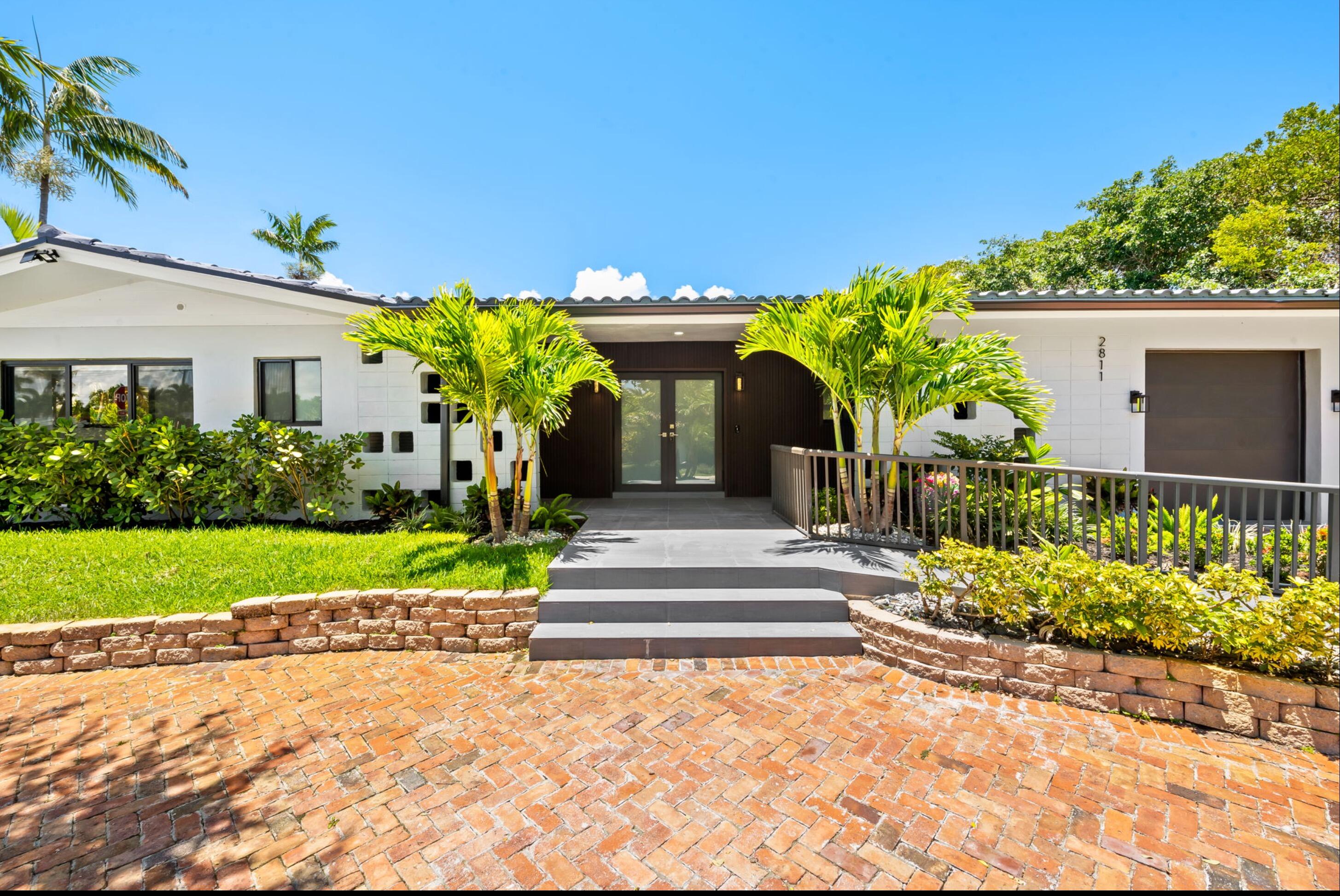 Must-see total new, not lived-in construction-captures the essence of relaxed coastal luxury living in prestigious area- exclusive community minutes from the beach.Own a completely reimagined & artfully crafted luxury RENOVATED FROM THE STUDS UP -exceptional attention to detail. Ultra-modern single-story estate blends sophistication with the ultimate South Florida lifestyle. This sleek contemporary home -generously sized 10,916 SqFt corner lot surrounded by lush tropical landscaping, It features  4-bedrooms, 3-baths with a desirable split floor plan & 3 ensuite bedrooms, luxury matte Porcelain tile finishes. Designed for both relaxation & entertaining; the spacious open-concept living areas flow seamlessly into your private yard. NO HOA. Salt Water Heated Pool & Spa. Featuring a heated saltwater 30'X15' resort-style pool and spa, expansive patio & lush foliage creating a secluded paradise atmosphere. Offering fenced property with complete privacy while embracing indoor-outdoor living at its finest. At the heart of the home is an open floor plan with designer's chef's kitchen showcasing custom cabinetry, island, premium stainless steel appliances, smart refrigerator, wine refrigerator & stunning quartzite countertops. The luxurious owner's suite offers serene pool & patio views creating a tranquil retreat complete with spa-inspired finishes including luxury master bathroom with soaking tub, waterfall rain shower, and refined custom cabinetry. Additional highlights include impact windows/doors, large circular driveway suitable for 5 cars ideal for entertaining. Perfectly located minutes to local beautiful beaches, marinas, waterfront restaurants, fine dining, and shopping.  Expansion potential too on large corner lot.