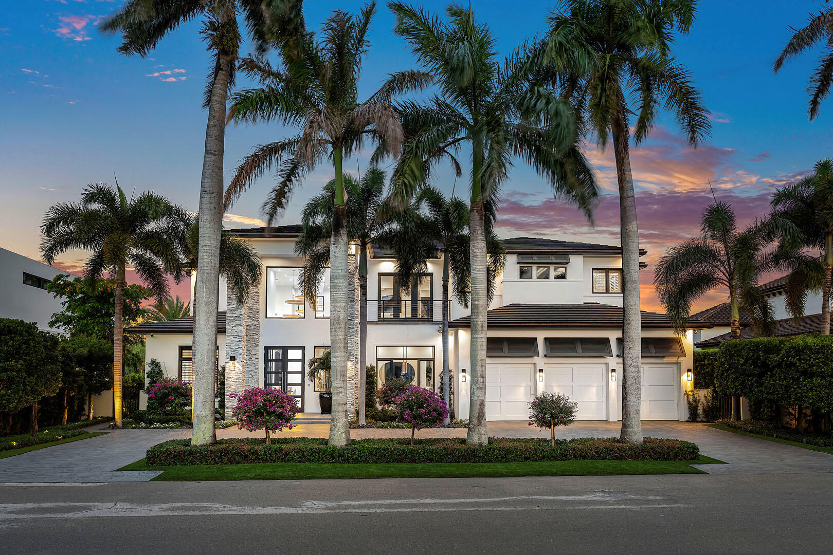 A rare opportunity to own one of only 14 exclusive residences within the prestigious Royal Palm Yacht & Country Club, offering uninterrupted front and rear vistas of the Jack Nicklaus Signature golf course. The interiors have been masterfully redesigned by renowned designer Michael Gray, showcasing a refined sensibility.
Step inside to find a dramatic entry that unfolds into a grand living space anchored by a striking floor-to-ceiling fireplace. The interiors are defined by custom architectural details, designer lighting, and curated wall treatments, all grounded by sleek white porcelain flooring on the main level.
Designed with both comfort and entertaining in mind, this four-bedroom home features a generous open layout that includes a sophisticated media lounge, a private study, multiple areas for gatherings, and a sprawling second-floor primary suite complete with a spa-inspired bath and a boutique-style dressing room.
Outdoors, the property captures the essence of serene living with sun-drenched eastern exposure. A covered terrace provides multiple seating and dining areas, while the summer kitchen and bar elevate alfresco entertaining. The elegant pool and spa complete a setting that delivers exceptional privacy and effortless luxury.