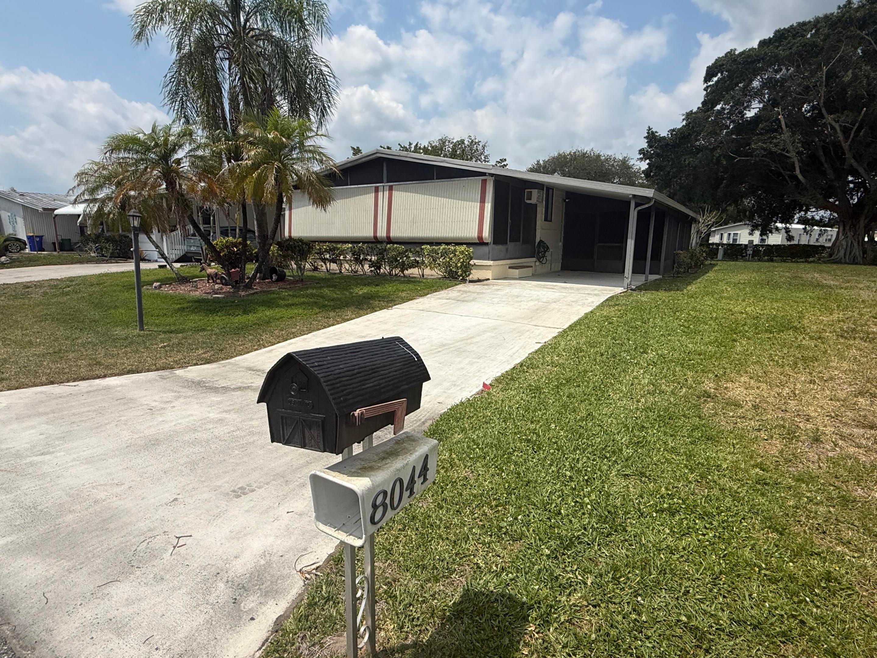 Updated 2 Bedroom/ 2 Bath Doublewide in Cambridge, 55+ community in Hobe Sound. New Custom Kitchen 2017 wide open to the LR & Dining Area w pull up seating, white Shaker cabinets, new appliances & deep kitchen sink. The Large Living room has a slider out to the front Florida Room.  There is also another FL room on the side of the home. Luxury vinyl plank flooring throughout except in Master. The Master Bedrm is large w walk in closet, updated (2018) ensuite bath w new vanity w dual sinks, step in shower & chair height toilet. All doors have been upgraded to 6 panel doors. The 2nd Bedrm is also a good size w updated full bath on the hall. There is a large laundry/storage room. Cambridge has an active clubhouse, heated pool, billiards, exercise room, & shuffleboard. YOU OWN THE LAND, PETS OK