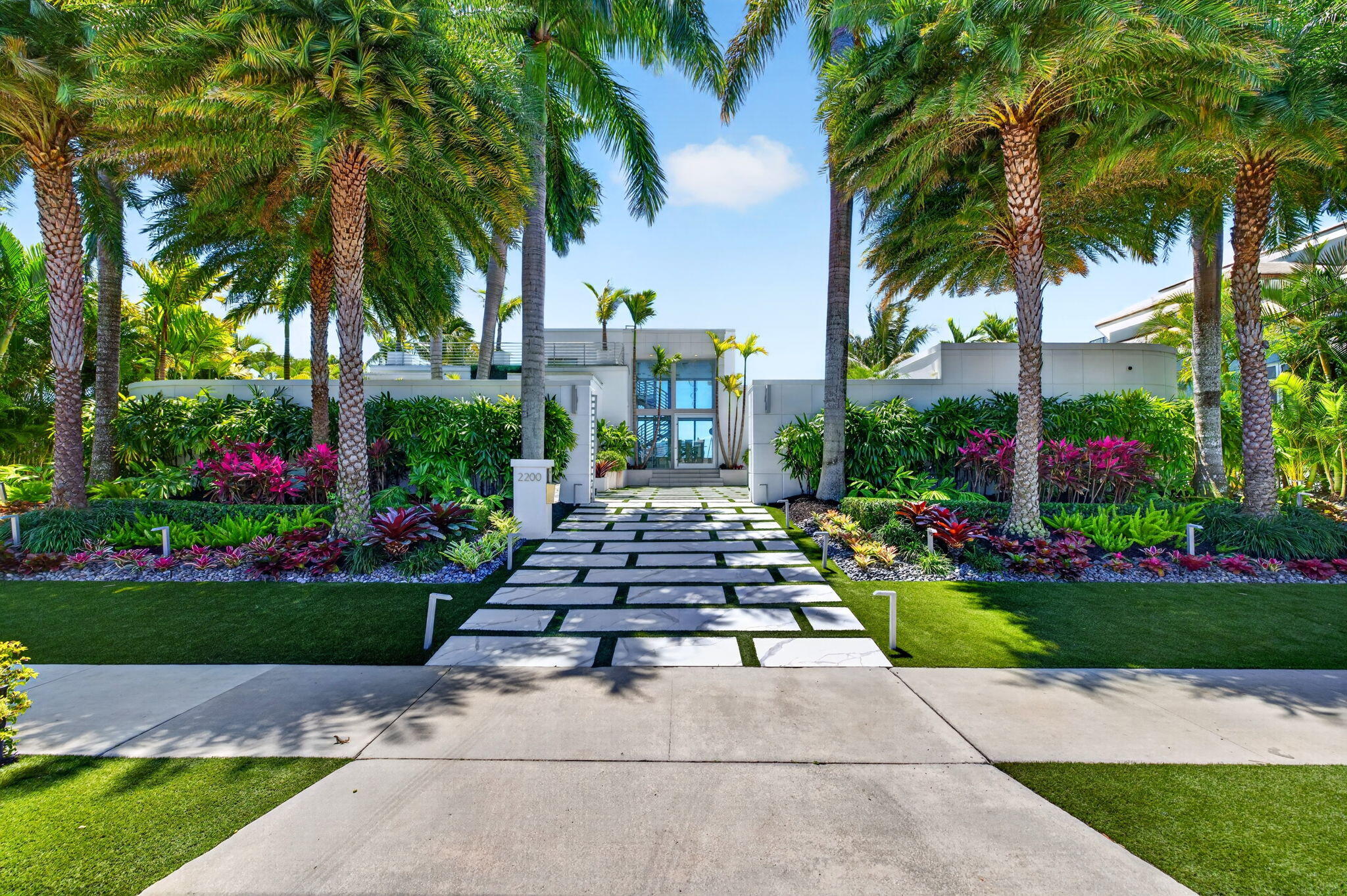 Rare opportunity to own one of only 10 exclusive estates along the Port Everglades Inlet, offering a private beachfront setting with impressive ocean and Intracoastal views. Enjoy a dynamic, ever-changing backdrop of boats, yachts, and cruise ships traveling to and from the Atlantic Ocean. Behind a gated 9-foot concrete perimeter wall, the home showcases ultra-luxury design and top-tier finishes throughout. The entire waterfront side is lined with expansive impact glass, creating seamless indoor-outdoor living and capturing stunning water views from nearly every room. Resort-style amenities include a pool and spa, subterranean beach cabana, pergola patio, and rooftop lounge. The furnished interior features a private theater with bar, home office, and a one-of-a-kind primary suite.