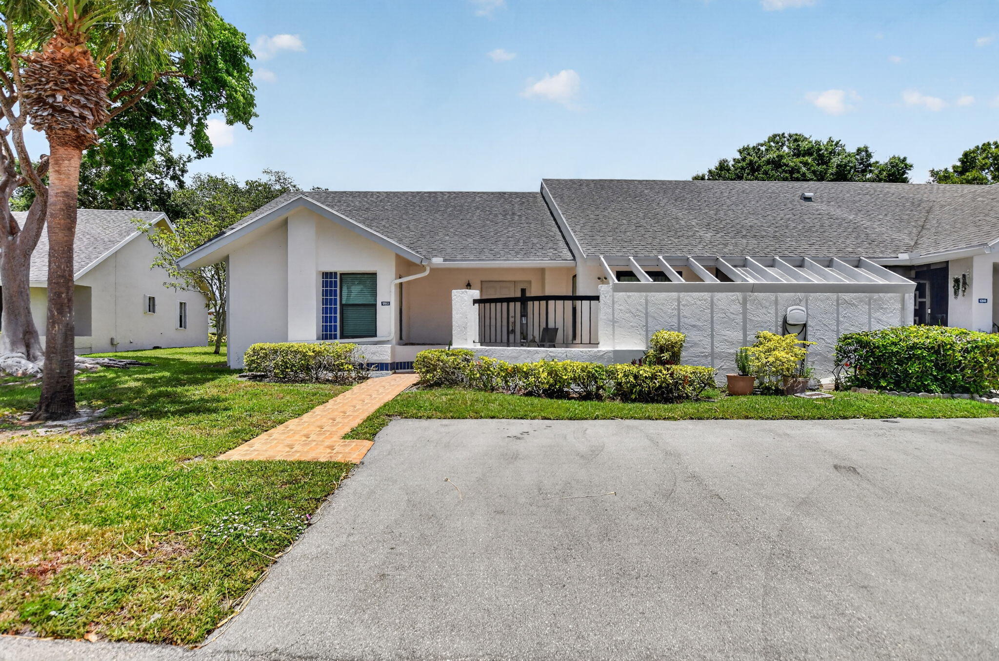 Welcome home to this immaculate 3-bedroom, 2-bathroom corner villa. Flooded with natural light,  features beautiful tile flooring throughout. The heart of the home is an updated eat-in kitchen, boasting elegant granite countertops and gleaming stainless steel appliances except the microwave is white. Enjoy total peace of mind with 2023 AC, abundant closet space, and hurricane-impact windows and doors. Unwind or entertain in the serene, enclosed patio. Move-in ready and designed for easy Florida living. This gated community features an active clubhouse, swimming pool, tennis courts, pickleball courts, sauna, fitness room. Per Association this is a 55 plus community.