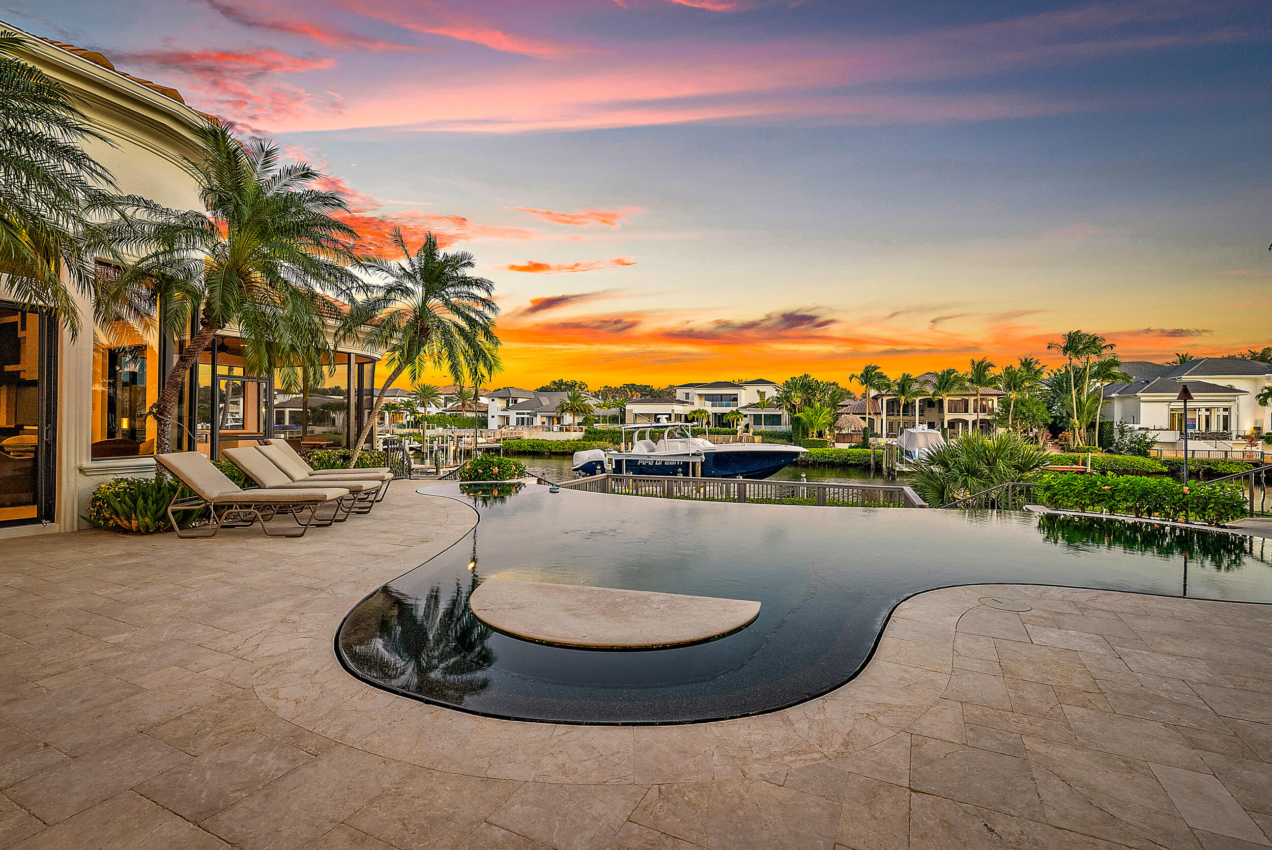 Waterfront Estate Home in Prestigious Admirals Cove.  This home boasts 5 bedrooms, 5.2 baths, private location on quiet cul-de-sac, close to the front gate and Club and all amenities.  The luxurious Primary Suite features a large sleeping room with views of pool and patio, laundry room,  1.5 baths, separate sitting/office and custom decorated walls.  3 additional en suite bedrooms on main floor.  There is also a 2 room suite upstairs that can be a private retreat or Club Room. Plenty of room for entertaining in several areas; dining room, living room with wet bar that extends to the outdoors and the family room that is open to the kitchen. Chef's kitchen with 2 stone and wood islands, gas cooktop, and stainless appliances all open to the family room and easy access to the pool, patio .... and screened in outdoor dining room. You will spend hours and hours basking in the Florida lifestyle either poolside or in the custom pool with built-in table for dining. The property is located within minutes of the Intracoastal Waterway with access to the Atlantic Ocean and has dockage for a large yacht. Admirals Cove is the premier Northern Palm Beach County Golf and Boating Community.