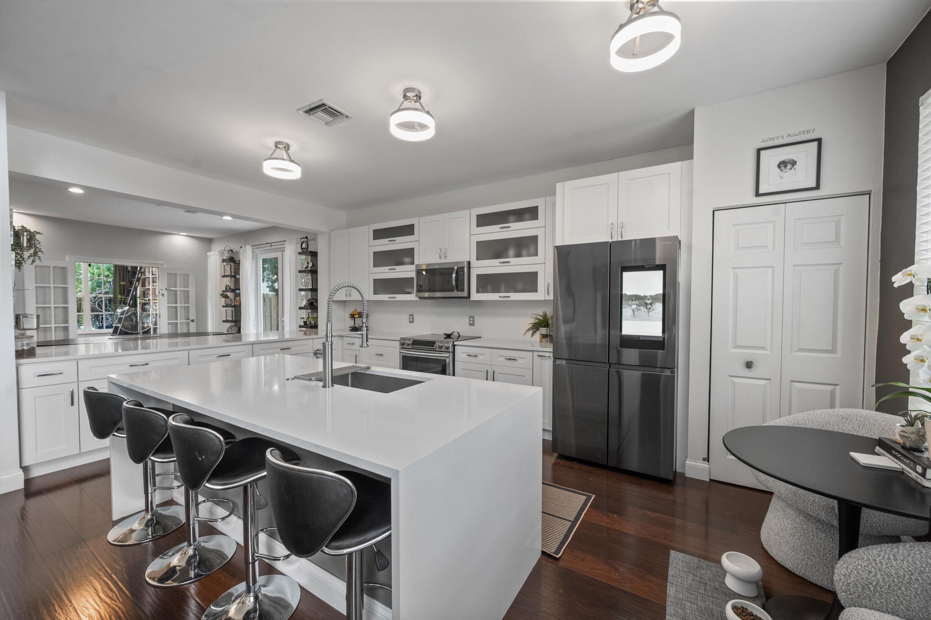 Welcome to this beautifully renovated 4-bedroom, 2.5-bath lakefront home in the highly sought-after community of Winston Trails. Perfectly situated on a serene waterfront lot, this residence combines modern updates with effortless Florida living. Step inside to discover a thoughtfully redesigned interior featuring a stunning new kitchen with stylish finishes, updated flooring throughout, and a luxurious primary bath renovation that creates a true spa-like retreat. Every detail has been carefully curated to offer both comfort and contemporary elegance. Enjoy seamless indoor-outdoor living with an extended outdoor space designed for entertaining. The custom summer kitchen overlooks tranquil lake views—ideal for hosting gatherings or relaxing in your private backyard paradise.  With spacious bedrooms, open living areas, and beautiful upgrades throughout, this home is truly move-in ready.