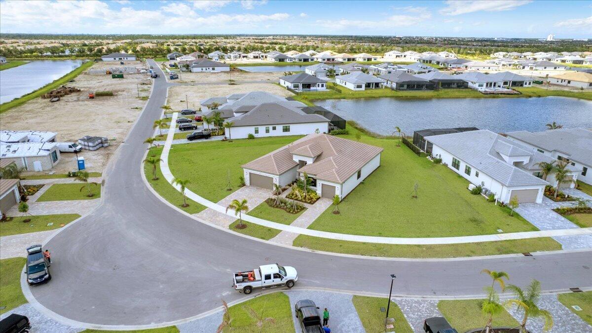 Beautifully upgraded 2025 Bellagio model in the highly sought-after 55+ community of Valencia Parc at Riverland. This spacious 3-bedroom, 3-bath home with a 3-car garage is situated on an oversized half-acre lakefront lot, offering exceptional privacy and plenty of room for a pool. Thoughtfully designed with an open-concept layout, this home features a formal dining room, spacious family room, private office with custom built-in cabinetry, porcelain tile throughout the main living areas, impact windows, motorized window coverings, whole-house water filtration system, and a gourmet kitchen with quartz countertops and abundant space for entertaining. Enjoy seamless indoor-outdoor living from the screened lanai and extended patio overlooking the tranquil lake views. Residents enjoy resort-style amenities including a clubhouse, fitness center, café/restaurants, pools, bocce ball, pickleball and tennis courts, and more. Conveniently located close to I-95, restaurants, shopping, medical facilities, and more.