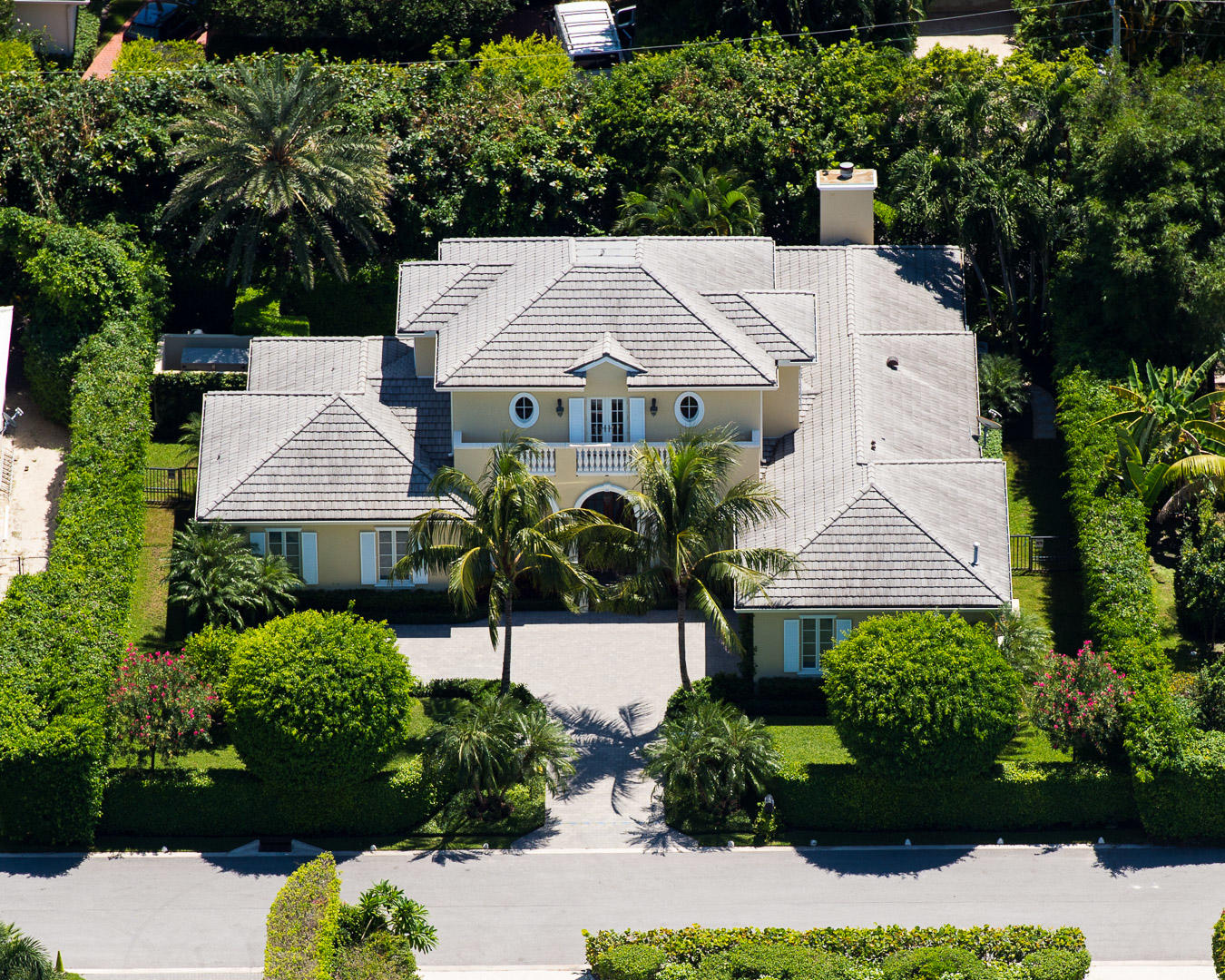 Beautiful British Colonial home built in 2003 with 5 bedrooms and 5 and a half baths. Welcoming motor court leads to covered entryway and 2 car garage. Classic tropical landscaping surrounds the property. Columned loggia with BBQ overlooks swimming pool. Fantastic chef's kitchen with top-of-the-line appliances and eat-at island leads to Great Room with fireplace. Kitchen and Great Room feature checkerboard marble flooring. Oversized Master Suite with dual baths and closets, terrace, and Juliet balcony. Full house generator.