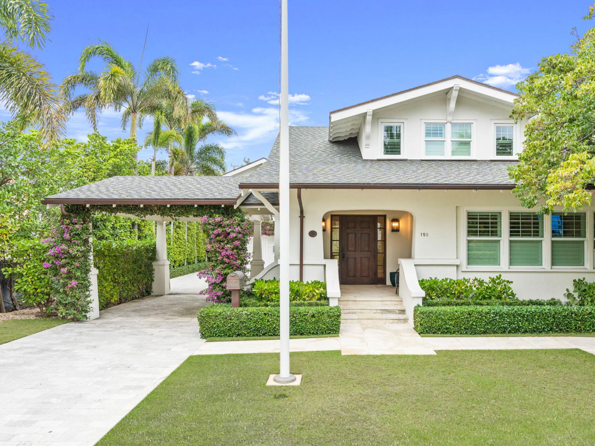Move in ready ocean block home with master on the first floor opens to a private backyard with beautiful pool and gardens.  Bougainvillea blossoms adorn the porte-cochere leading to the charming entry porch. Inside, a welcoming foyer with a window seat and custom built-ins leads you to the formal living and dining room. The home is replete with pristine hardwood floors throughout, all new kitchen and bathrooms, full impact glass, and a first floor primary suite. Upstairs are two more guest bedrooms and a bonus room that would make a great home office or den. Attached to the main house by a breezeway is a 2 car garage with an exercise room, utility/laundry room, and a second story guest cottage with two bedrooms and bathrooms, and a living room. A heated pool is perfectly sited in the lushly landscaped gardens between the guest and main house. Landmarked in 2012 after extensive renovations this beautiful home was the winner of the Preservation Foundation's Polly Earl Award for its incredible attention to detail.