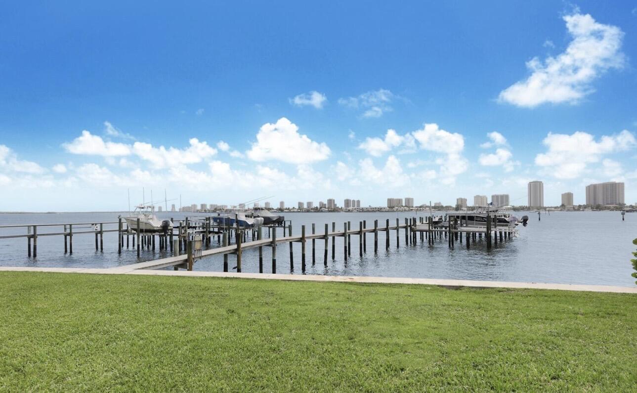 Escape the cold and spend your season in paradise!   Wake up every morning to breathtaking million-dollar Intracoastal views from every window and door. Enjoy your coffee while watching boats and yachts glide by, then end each day with spectacular sunsets and refreshing ocean breezes.  Welcome to your completely renovated ,never lived in furnished 2-bedroom, 2-bath waterfront condo, located in a boutique building with only 7 exclusive residences. Every detail has been thoughtfully designed so you can simply arrive, unpack, and start enjoying the South Florida lifestyle.  Just bring your suitcase and toothbrush—everything else is waiting for you!  Includes one assigned parking space.  Ideally located just steps from Phil Foster Park, Peanut Island and the beautiful beaches of Singer Island. Enjoy easy access to waterfront restaurants, marinas, shopping, spas, and endless opportunities for boating, snorkeling, fishing, paddleboarding, and beach days.  Whether you're escaping the winter, working remotely from paradise, or looking for the perfect seasonal retreat, this waterfront oasis offers everything you need for an unforgettable stay.  Your Palm Beach getaway is waiting—reserve your season before it's gone!