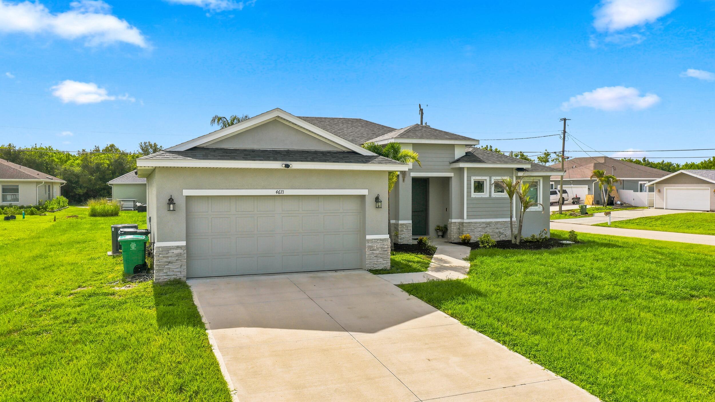 Experience modern luxury in this exceptional 2023 custom-built residence perfectly positioned on an oversized corner lot. Designed with elegance and functionality in mind, this stunning home showcases soaring ceilings, expansive living spaces, designer finishes, quartz countertops, custom cabinetry, and a chef-inspired kitchen that flows seamlessly into the open-concept living area.  Retreat to the luxurious owner's suite featuring a spa-inspired bath and generous walk-in closets. Impact windows and doors provide peace of mind, while the covered lanai and spacious backyard offer endless possibilities for outdoor living and entertaining.  Ideally located near Tradition, premier shopping, dining, top-rated medical facilities, I-95, and the Florida Turnpike. Schedule your Castle Tour today!
