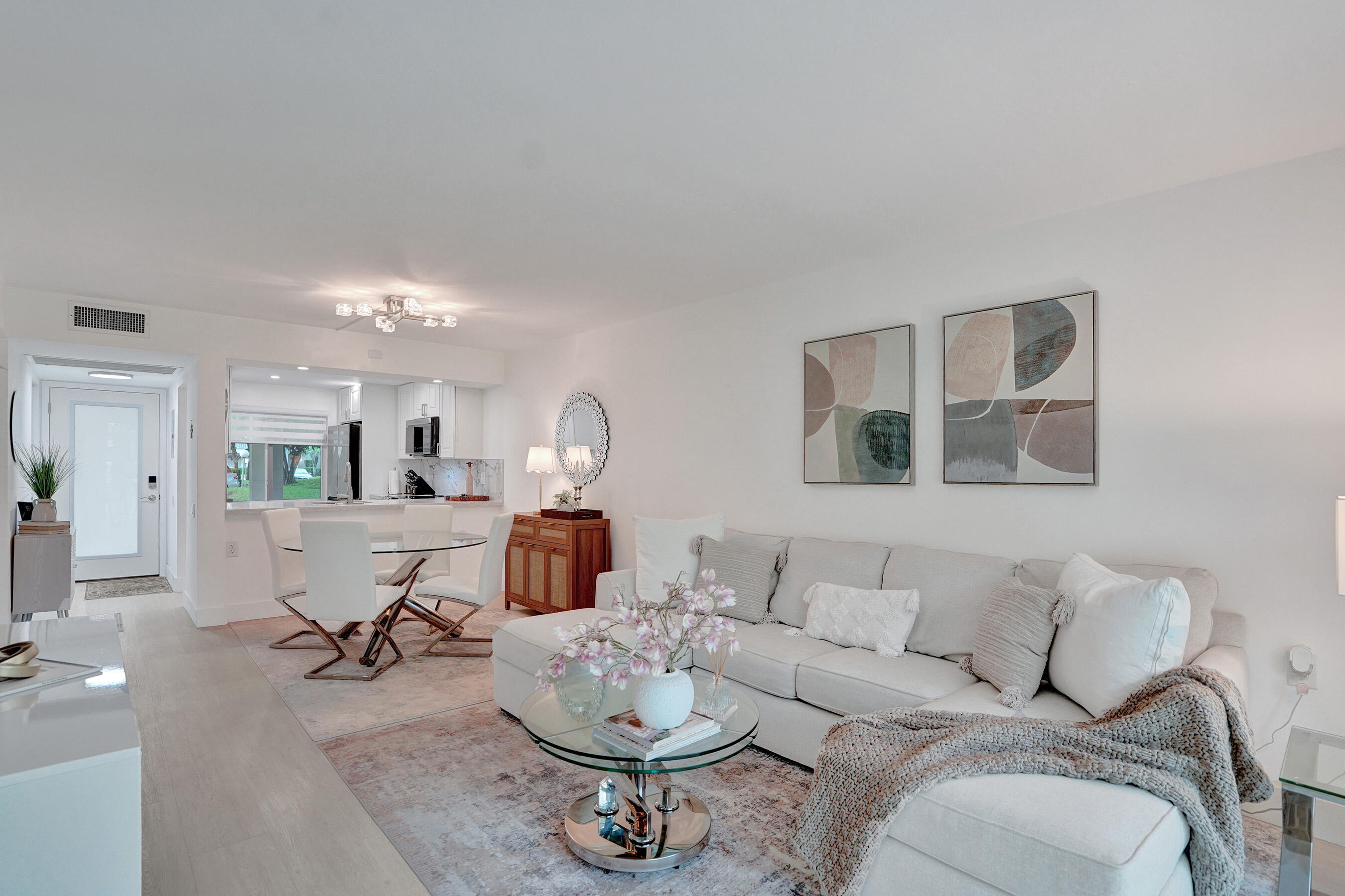 Beautifully renovated first-floor condo in the highly sought-after Wynmoor community. This move-in ready residence features impact windows and doors, brand-new A/C, updated electrical, modern flooring, and stylish finishes throughout. The bright and spacious layout offers an updated kitchen with contemporary cabinetry and ample storage, renovated bathrooms, generous closet space, and abundant natural light. Enjoy your private screened patio, perfect for relaxing and enjoying South Florida's year-round sunshine. Conveniently located close to the clubhouse and community amenities, including golf, tennis, pickleball, fitness center, pools, theater, transportation services, and a wide variety of social activities. Ideally situated near shopping, dining, medical facilities, and major highways.  A beautifully updated turnkey home offering comfort, convenience, and resort-style living at its best.** Must See!**
