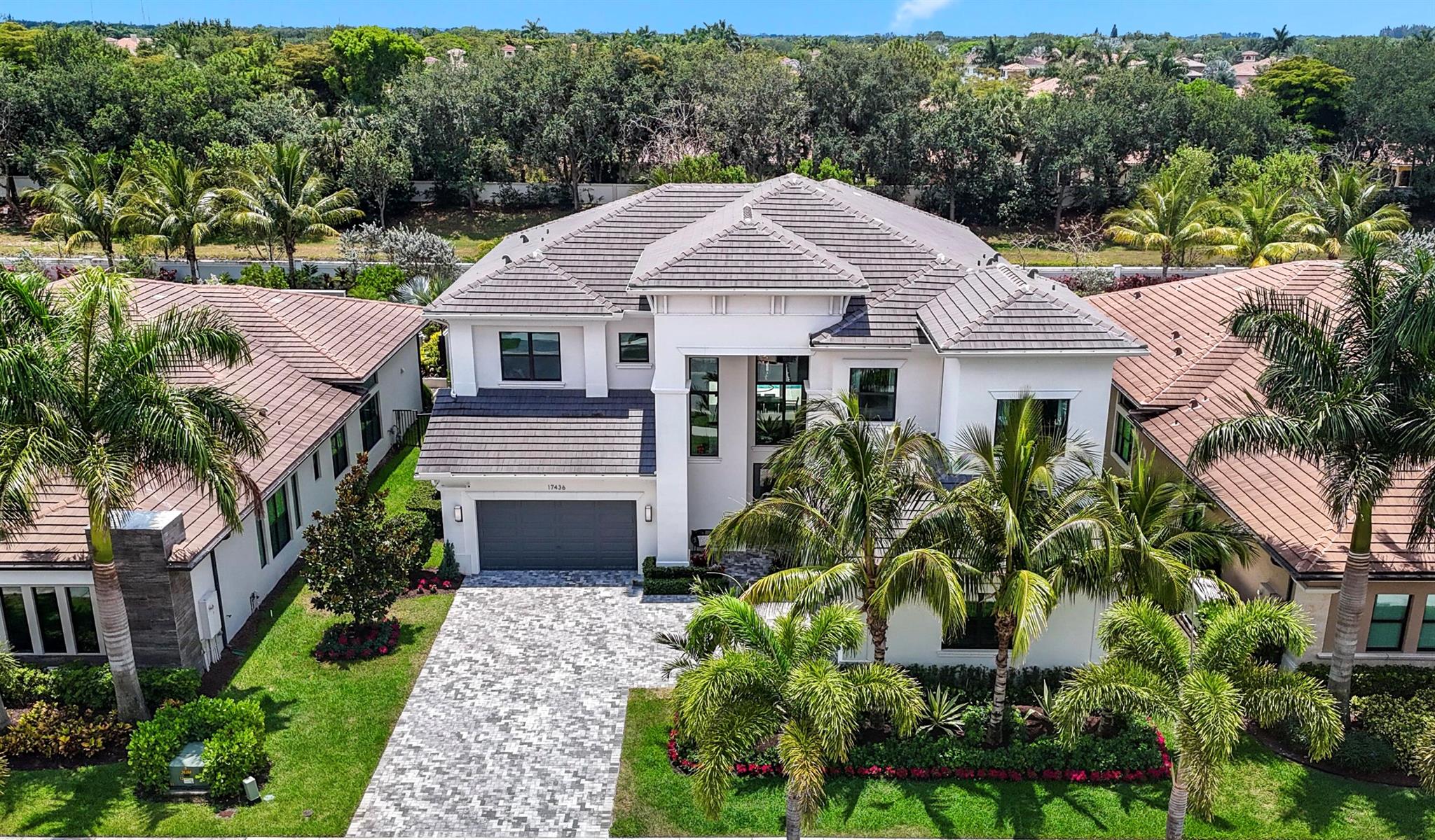 This Absolutely Stunning, Turnkey, Riverside Model Home is the most sought after model in all of Boca Bridges. Just bring your toothbrush and move right in! Live the ultimate country club lifestyle in this newly built 5 bedroom, 7 bathroom home encompassing almost 6,000 square feet of living space without the country club fees. Upon entering this spacious, open and inviting home, guests are greeted with beautiful, light colored, wide plank, wood floors and a grand 2 story entrance which leads you into a very large Great Room. Enjoy preparing meals in the adjacent gourmet, chef's kitchen, featuring a very large kitchen island with seating up to 5 and top of the line appliances including Subzero and Wolf. Enjoy entertaining guests and unwinding over dinner in the gorgeous dining room which seats up to 10 comfortably with a magnificent floor to ceiling all glass built in Wine Closet. Enjoy playing a game of billiards or watching your favorite movie in the first floor club room with its built in wet bar area. Or Spend some time relaxing in your Large Private Backyard Paradise offering a gorgeous salt-water heated pool, fully turfed lawn and full outdoor kitchen BBQ area.  At the end of the night, head upstairs to the loft to unwind some more with a glass of wine from the upstairs wine bar. Or curl up on the sofa on your outdoor balcony overlooking the pool, with your favorite book. In addition to the upstairs loft, the second floor has a large laundry room with plenty of storage space, and 4 generously sized ensuite bedrooms.  Be dazzled by the Primary Suite, with its 2 large walk in closets, a sitting area, a spa-like bathroom retreat with a double sized glass enclosed shower and a huge soaking tub. The fifth ensuite bedroom is located on the first floor and perfect not only for guests, but can be used as an in-law suite or nanny's room if need be. This exquisite residence features high-end lighting throughout the home from Restoration Hardware which sets the stage for lovely evening entertaining. Beautiful landscape lighting has been installed in the front of the home as well as in the back to enhance the beauty of the professionally landscaped areas. Everything has been carefully appointed and thought out in this home including the installation of a whole house generator so you can rest easy if the power were to ever go out! This rare gem of a home is nestled in the confines of the prestigious gated club community of Boca Bridges. Tennis, Pickleball, A Resort Style Pool, Full Service Restaurant and Bar, Fitness Center, Indoor and Outdoor Basketball Courts, and planned adult and child activities and events throughout the year are just some of the club's many offerings. Come discover for yourself this meticulously designed home offering every modern convenience and live the ultimate dream life without the country club membership price tag and fees! Do not wait to book a viewing! This One will not last! Being offered furnished or unfurnished!