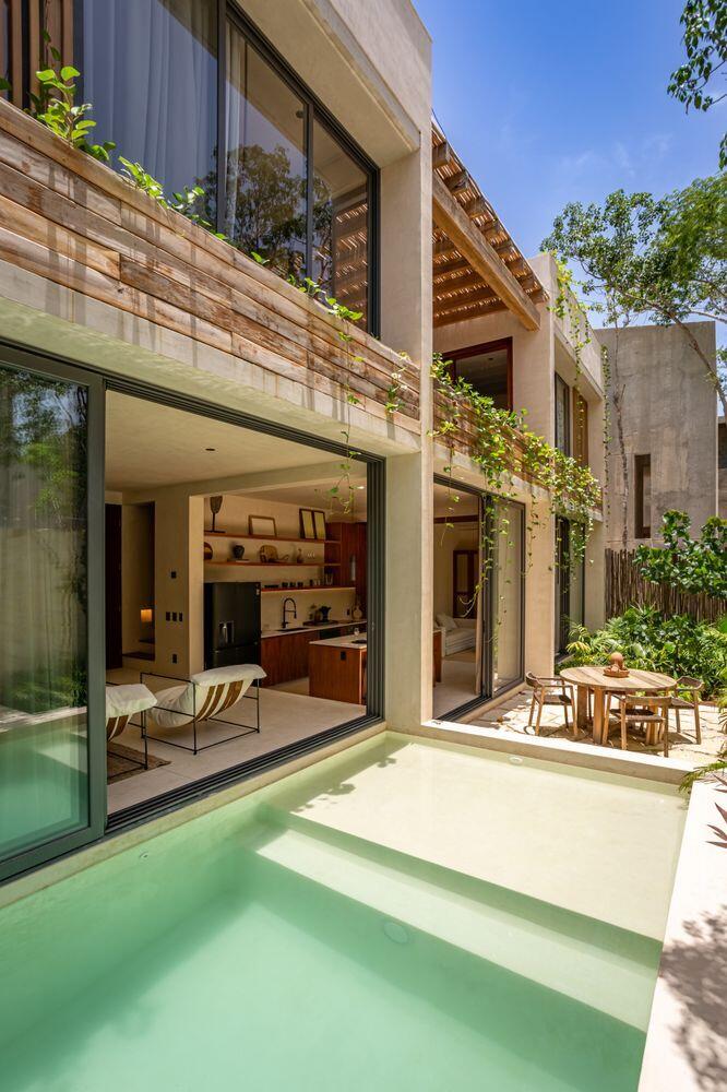 Beautiful 3-bedroom, 3-bathroom villa located in the gated AMARI Uptown community in Tulum. Delivered and ready for immediate use. This three-level home offers a functional layout with seamless indoor-outdoor living. The ground floor features an open-concept kitchen, dining, and living area that connects directly to a private garden and pool. A flexible enclosed space on this level can be used as a third bedroom, office, or additional guest area, along with a full bathroom. The second floor includes two bedrooms, including the primary suite with en-suite bath and terrace access, providing separation and privacy from the main living areas. The third level features a rooftop terrace with open lounge space, suitable for outdoor use and entertaining. Finishes include chukum walls, polished con