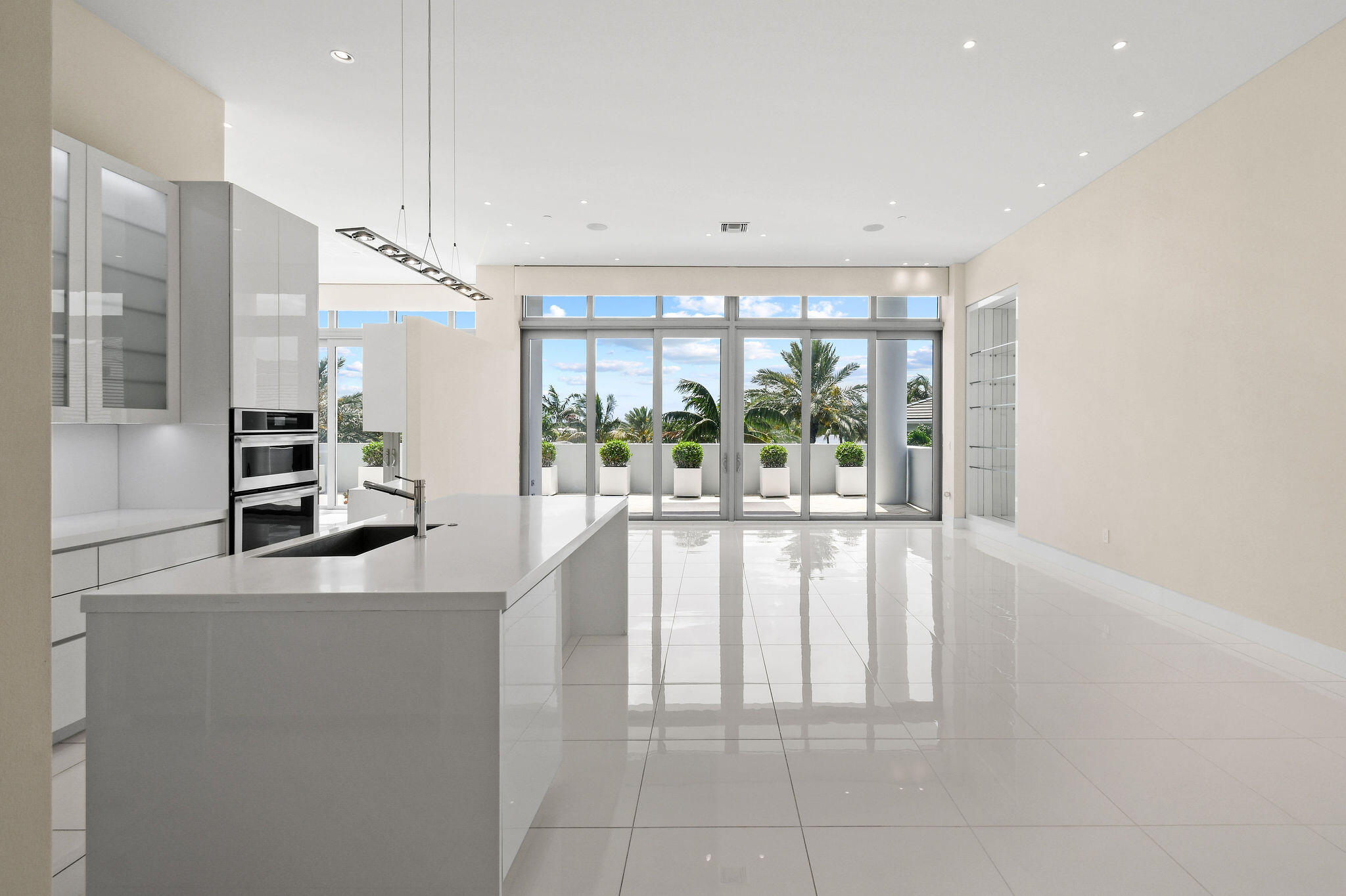 Step through the lobby level entry of this Water Club residence into ceilings that hold steady at twelve feet through every room. The great room spills onto a wraparound terrace, thirty seven feet across, facing an Intracoastal that stretches like a ribbon of light. Two en-suite bedrooms with a third converted to an office and three full baths unfold with the ease of a home built for entertaining, anchored by a primary suite with separate bathrooms and separate walk in closets. A custom kitchen sits at the center of it all, built less like an afterthought and more like the heart of the home. Porcelain tile, twenty four inches square, runs the length of the home like a single unbroken thought. The building's resort style amenities are the best in North Palm Beach. Unparalleled location.