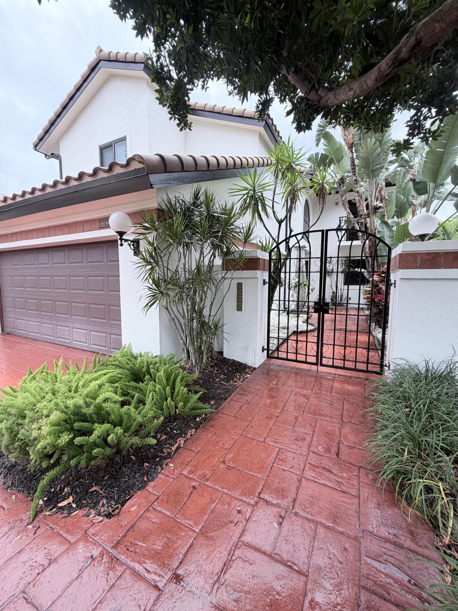 Beautifully remodeled and impeccably maintained, this stunning 4-bedroom, 3-bathroom residence is nestled within the exclusive, guard-gated Villa Flora community of Boca Pointe. This two-story home delivers the perfect blend of sophistication, comfort, and South Florida lifestyle. The heart of the home is a sleek, designer kitchen featuring glossy white cabinetry, an oversized waterfall island, high-end appliances, and custom built-ins, a true chef's dream. An open-concept floor plan flows seamlessly into the dining and living areas, creating a bright and airy atmosphere beneath soaring ceilings and clean architectural lines.   Upstairs, each bedroom boasts its own private balcony, offering serene views and the ultimate indoor-outdoor living experience. The primary suite is a peaceful retreat featuring two walk-in closets, while the additional bedrooms offer generous space and flexibility for family or guests.  Step outside to your own private oasis, a sparkling private pool surrounded by expansive outdoor entertaining spaces, built in barbecue perfect for hosting or simply unwinding. Located in one of Boca Raton's most sought-after gated communities, residents enjoy the security and prestige of Villa Flora while being minutes from world-class dining, upscale shopping, beautiful beaches, and top-rated schools.