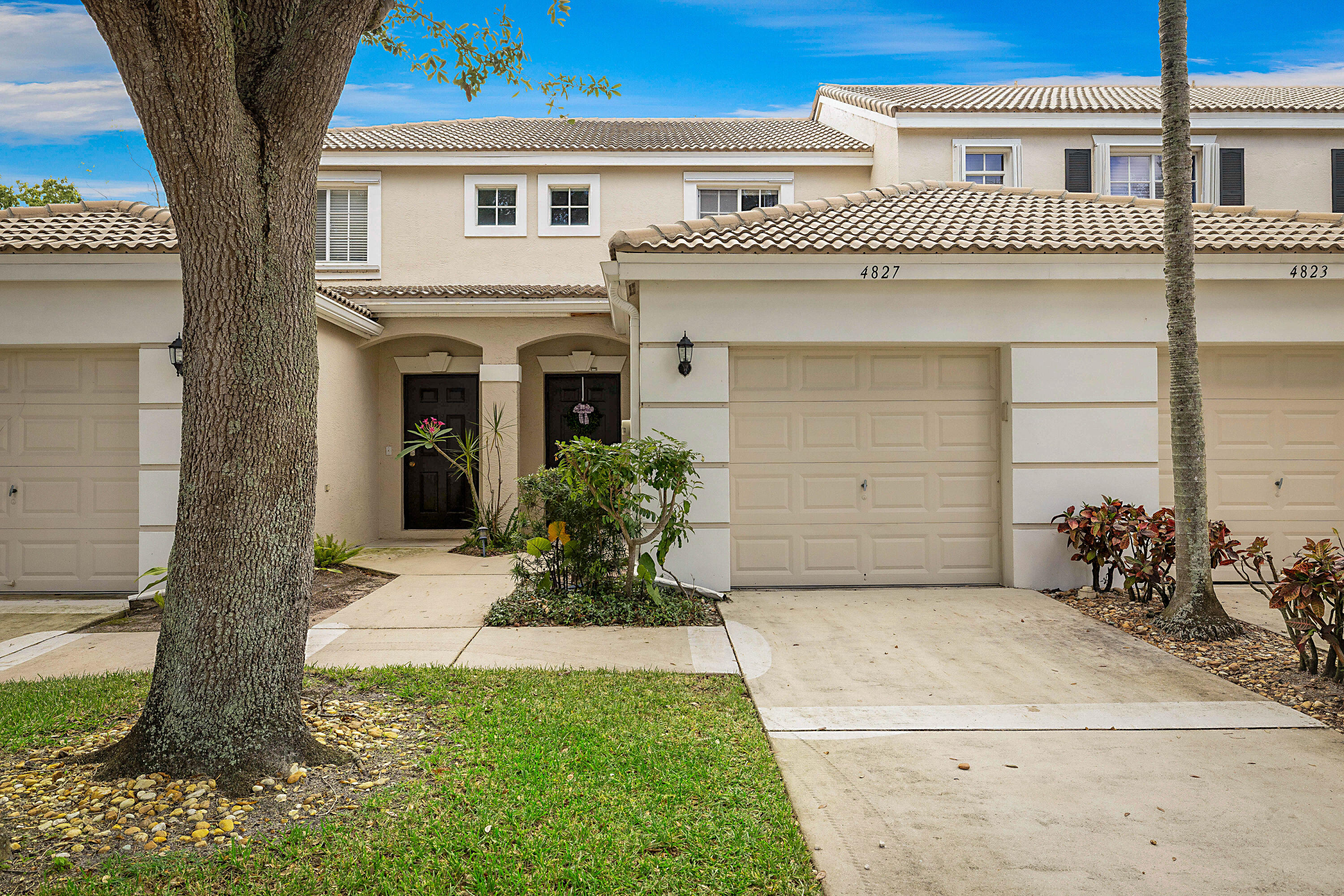 Tucked inside the gated community of Jonathan's Cove, this beautifully maintained 2-bedroom, 2.5-bath townhome offers the perfect blend of comfort, convenience, and Florida living. Bright and welcoming, the home has been lovingly cared for and features tile and wood flooring throughout. The spacious kitchen is equipped with stainless steel appliances, while the gorgeous washer and dryer add a touch of luxury to everyday living. Upstairs you find two primary bedrooms both with en suite bathrooms. An attached 1-car garage provides additional storage and convenience. One of the home's most inviting features is the screened patio overlooking private tropical landscaping, creating a peaceful outdoor retreat for morning coffee, evening relaxation, or entertaining friends. Residents of Jonathan's Cove enjoy an array of amenities, including a resort-style pool, fitness center, sand volleyball court, playground, and scenic walking trail surrounding the community lake.  Within close proximity to this townhome you will find an abundance of guest parking making it easy to entertain. Ideally located just minutes from Palm Beach International Airport, pristine beaches, shopping, dining, and major roadways, this move-in-ready home offers a carefree lifestyle in one of West Palm Beach's most convenient locations. Come experience the charm, privacy, and easy living this special property has to offer.
