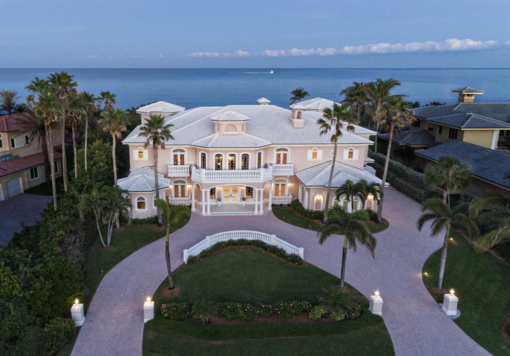 Oceanfront living on a grand scale in this spectacular seaside manor.  Formal living area welcomes guests with its oceanfront views.  Adjoining dining room includes butler's pantry & custom wine room.  Gourmet kitchen & adjoining family area offer extensive room for entertaining & casual living.  Kitchen features custom cabinetry, granite countertops & massive center island with abundant storage. The home's private quarters exude quiet opulence, with uniquely situated en-suite baths and imported Versace tile throughout. Outdoor spaces feature heated swimming pool & spa, private dune walk to beach & summer kitchen set within a gazebo.