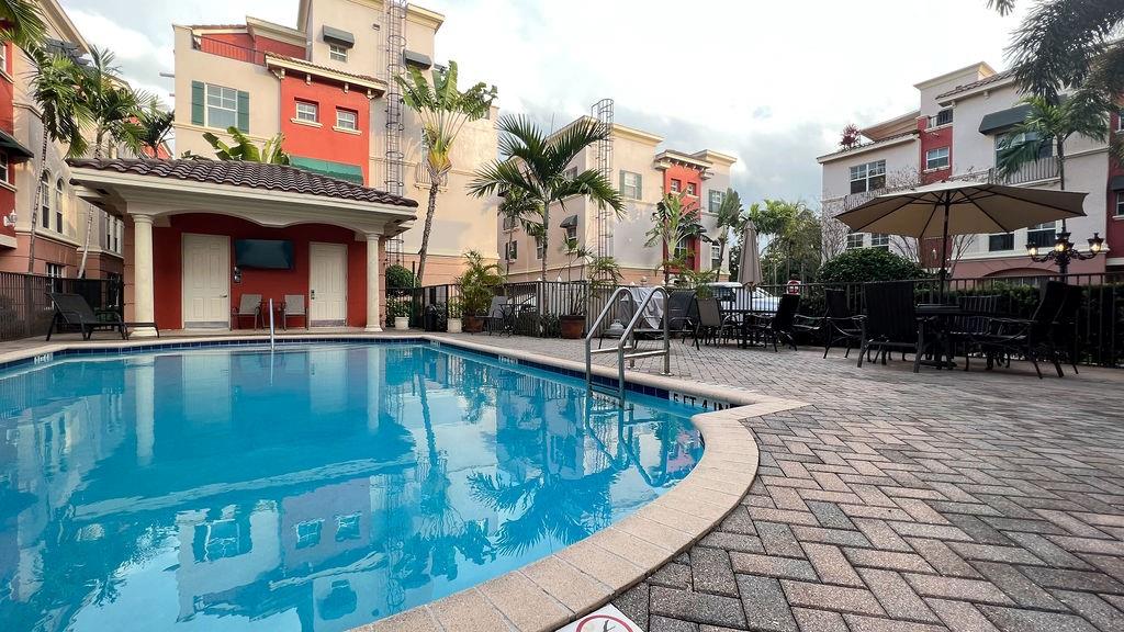 LETS TAKE A TOUR OF THIS GATED TOWNHOUSE COMMUNITY LESS THAN 1 MILE TO THE WORLD FAMOUS FORT LAUDERDALE BEACH. DRIVE PAST THE GUARD AND INTO A PRIVATE GATED ENCLAVE OF SUPERIOR TOWN HOMES. PULL INTO YOUR PRIVATE OVER SIZED GARAGE, WALK PAST A FIRST FLOOR GUEST SUITE ON YOUR WAY TO THE 2ND LEVEL OPEN LIVING, DINING AND MASSIVE KITCHEN COMPLETE WITH UPGRADED APPLIANCES AND LAUNDRY. NOW UP TO THE PRIVATE 3RD LEVEL MASTER SUITE WHICH INCLUDES A BATHROOM TO DIE FOR. NOT TO MENTION A SPACIOUS CUSTOM CLOSET. NOT DONE YET! TAKE THE STEPS UP TO THE 4TH FLOOR AND YOUR HEADS ARE IN THE CLOUDS WITH THE FOREVER VIEWS FROM YOUR VERY OWN ROOFTOP TERRACE.