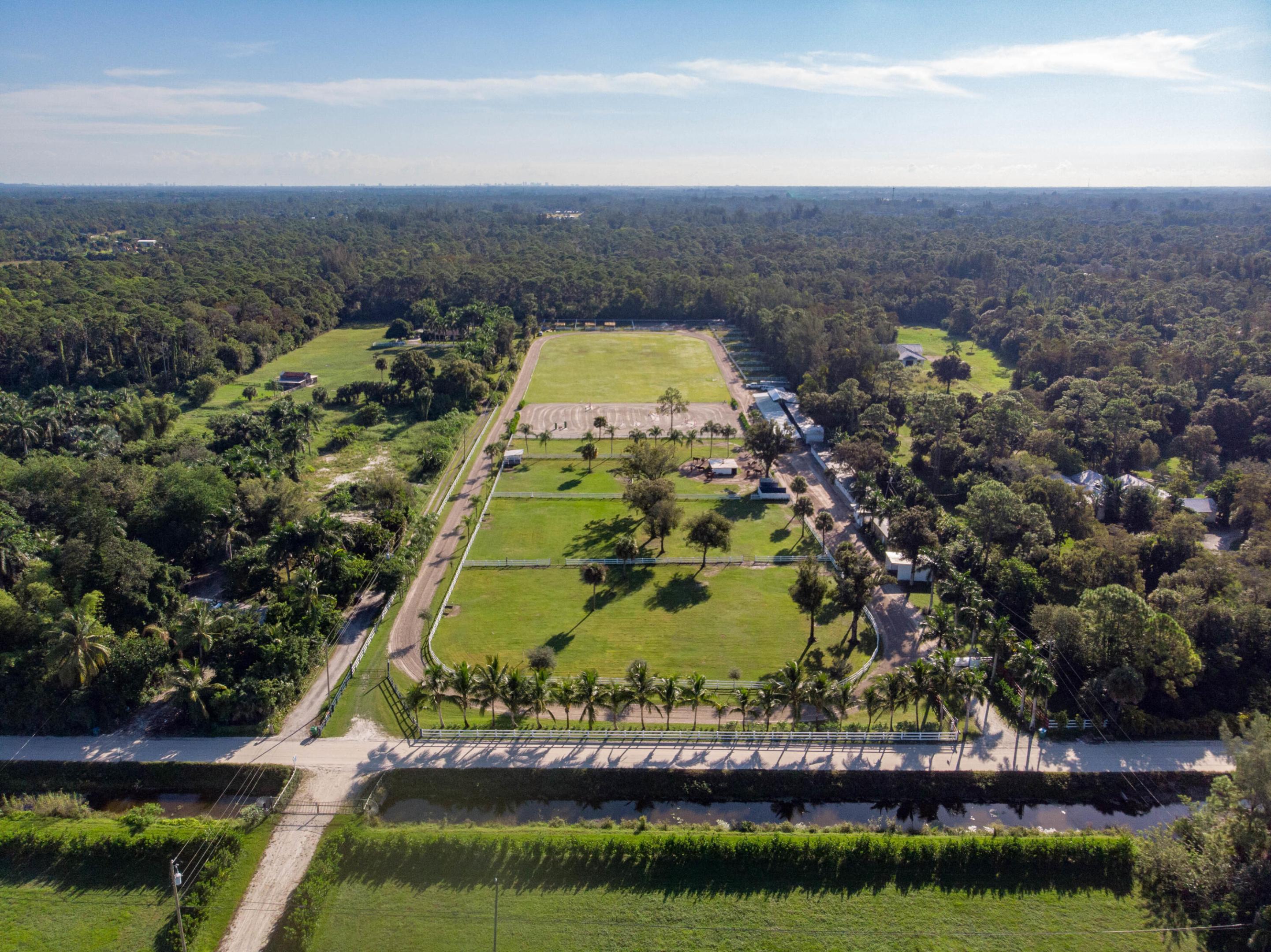 Beautiful 10 acres equestrian property for sale on D Rd in Loxahatchee Groves. Less than 15 minutes from Wellington horse show and polo venues. Located on the South side of Okeechobee Blvd between Binks Forest and Palms West Hospital. Paved road with convenient highway access with a traffic lights at D Rd and Southern Blvd. The property currently has an agricultural exemption. Fenced, cleared and graded. High and Dry (drainage ditch). Water and electric are installed. No easement, no wetlands, no pond and no power lines. Currently a polo horse farm with 22 stalls (wood pole barn). 6 acres Bermuda polo field. Great opportunity to own a large parcel of land minutes from Wellington. Need more land? Adjacent parcels for sale for up to 20 acres: 10 acres (1044 D Rd) and 5 acre (1068 D Rd).
