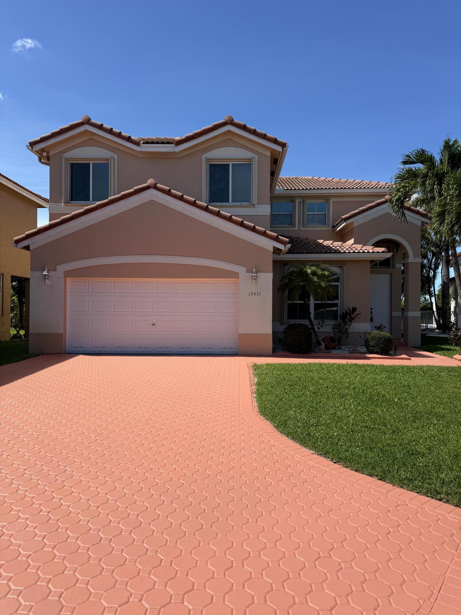 Beautiful lakefront 4-bedroom, 2.5-bath residence with a 2-car garage located in the gated community of Monarch Lakes in West Miramar. This well-maintained home features a dramatic two-story living room filled with natural light, tile flooring throughout the main level, and wood laminate upstairs. The functional layout includes separate living and family rooms, a breakfast area, and a formal dining space, ideal for both everyday living and entertaining. Step outside to a spacious private backyard offering mature landscaping, serene lake views, and no rear neighbors for added privacy. Situated on a quiet cul-de-sac with an expansive driveway and accordion shutters for storm protection. Conveniently located near I-75, the Florida Turnpike, and SR-826, and zoned for top-rated schools, this ho