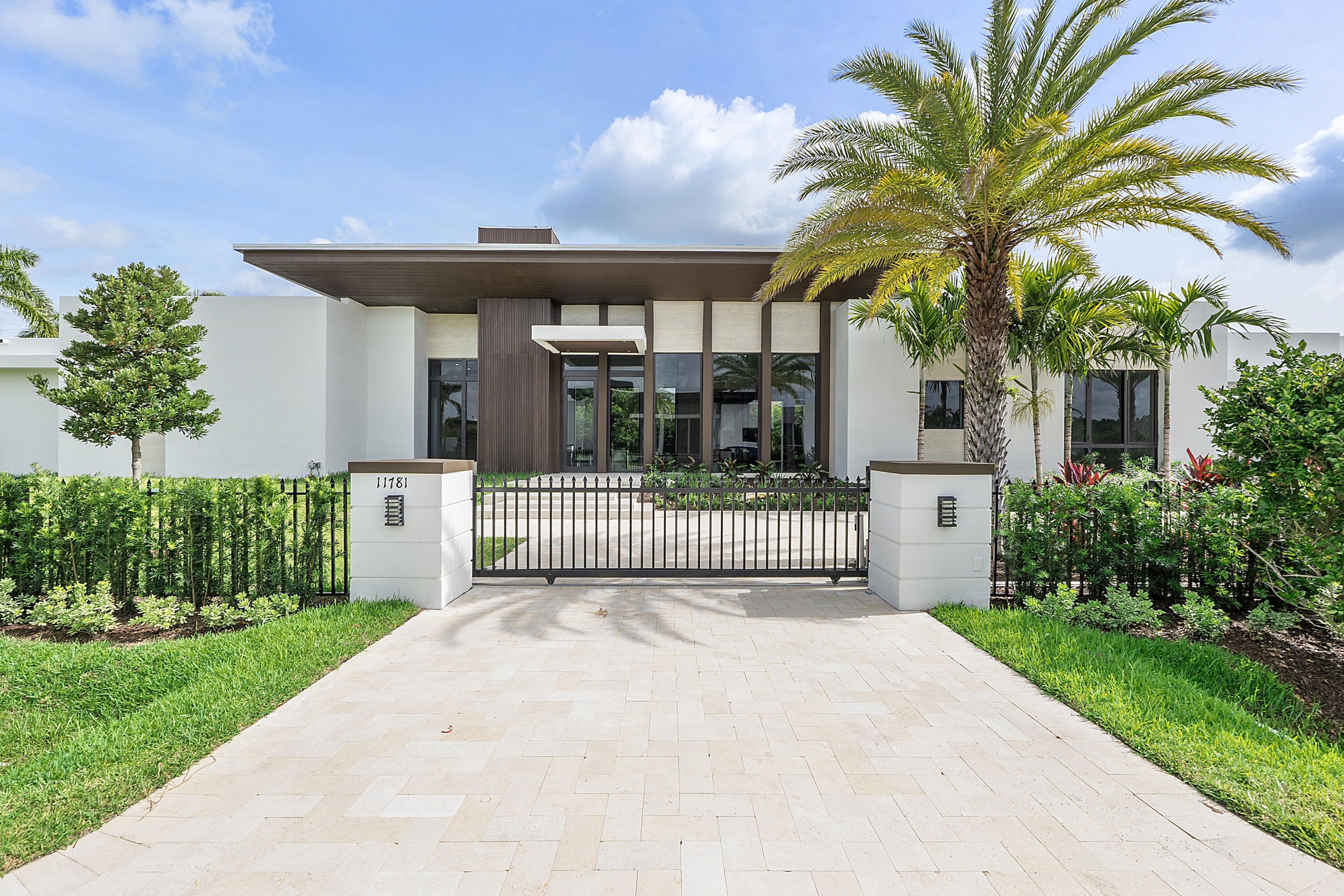 Newer construction in Plantation Acres Estates, an exclusive gated community of just 5 custom homes on builder's acres, designed by renowned architect Randall Stofft. This modern estate features 5 bedrooms plus an oversized club room and private office, 5 full and 2 half baths, and 2 wall-mounted fireplaces in the formal living and family rooms. Highlights include a 3-car garage, 3 A/C zones, impact windows, Silestone countertops, and large-format porcelain floors. The luxurious primary suite offers a private terrace and spacious dual closets, with a spa-like bath. Gourmet kitchen with top-tier appliances, gas cooktop, and sleek cabinetry. Resort-style backyard with infinity pool, spa, summer kitchen, covered patio, cabana bath, and lush landscaping.