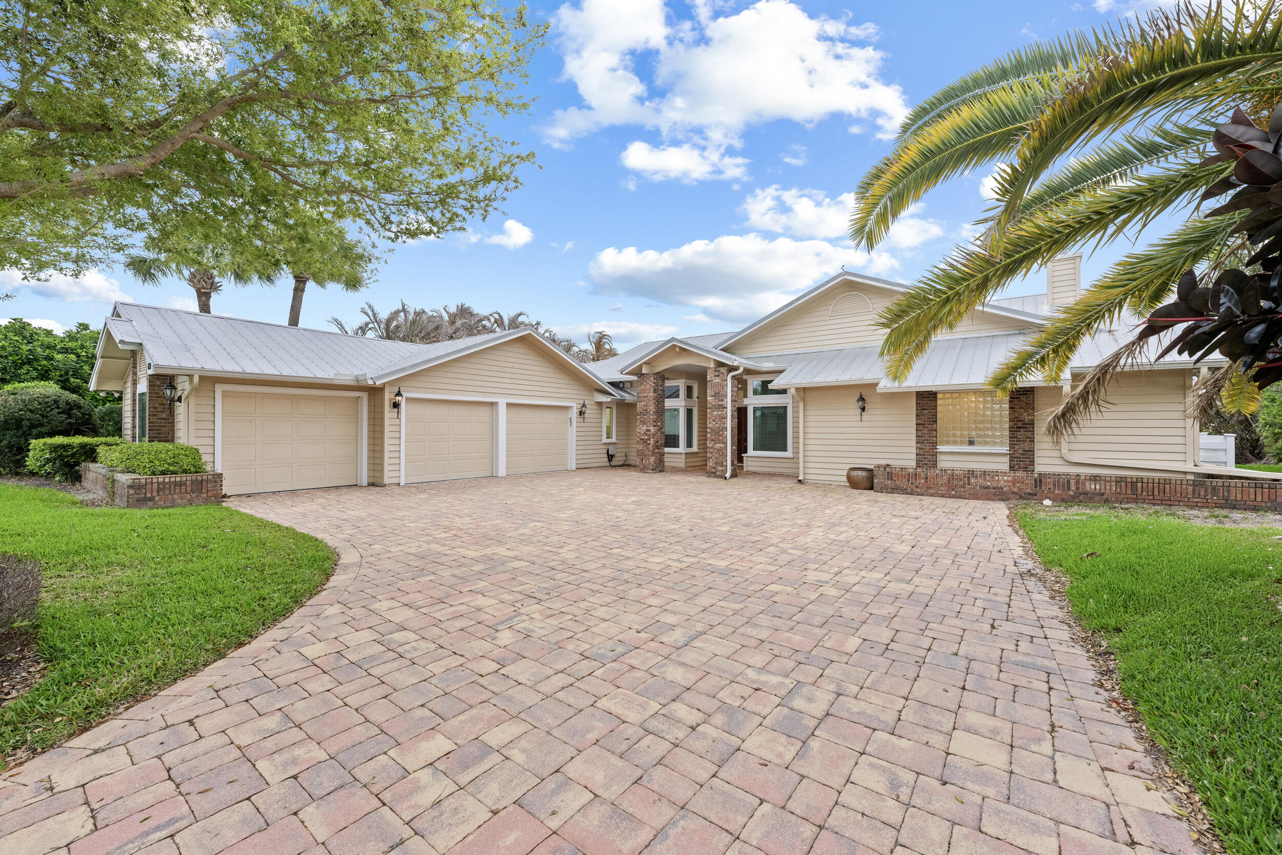 Stunning 4 bedroom, 3 bathroom waterfront home offering over 3,200 sq ft of living space in a guard gated community. This beautifully appointed property features a 3 car garage, private dock with boat lift, and direct Intracoastal access, perfect for boating enthusiasts. Enjoy outdoor living with a heated inground pool and covered lanai, ideal for relaxing or entertaining. Interior highlights include a fireplace, custom wood built ins, impact windows, and a whole house generator for added peace of mind. Topped with a durable metal roof, this home combines comfort, style, and functionality, all just minutes from shopping, dining, and the beaches.