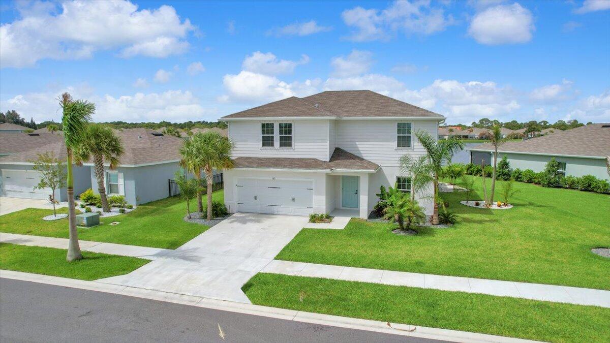 Built in 2024 and enhanced with over $60,000 in owner-added improvements, this lakefront home in Avalon Crossing stands apart from typical new construction. Situated on a lushly landscaped corner lot with lake views, the home features upgraded tile & luxury vinyl plank flooring, motorized shades, custom blinds, ceiling fans throughout, & a Samsung Bespoke refrigerator. The finished garage, security cameras, rain gutters, and irrigation system add everyday convenience. Outside, the impressive 26' x 16' screened lanai features epoxy flooring, three ceiling fans, and a six-person spa with Wi-Fi, LED lighting, and approximately 80 jets. Residents enjoy access to the community pool & amenities while being conveniently located near shopping, I-95, downtown Fort Pierce, and beaches.