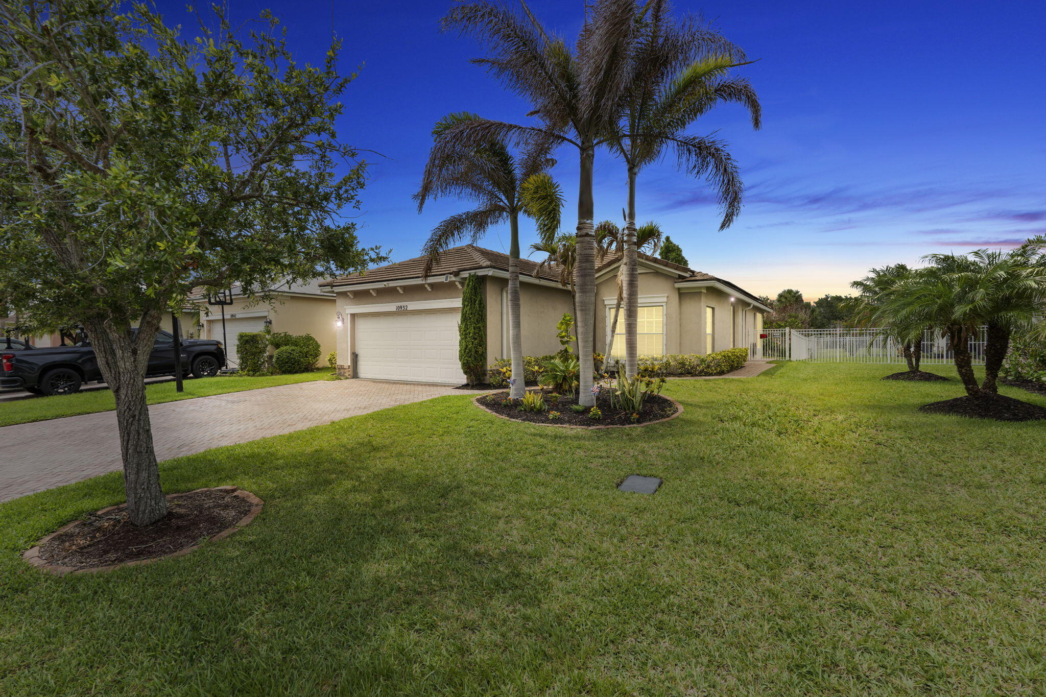Location! Location! Discover this Beautifully Updated CBS Home nestled in Heritage Oaks, in Tradition. Offering 3 bedrooms, 2 bathrooms, and a 2 Car garage, this Meticulously Maintained Residence blends timeless elegance with modern efficiency! This Home has it ALL! Solar Panels have been PAID in Full! Newly Remodeled Guest Bathroom (2022), A/C (2022), W/H (2020). Extensive Upgrades ALL completed in 2022.  Step inside to an Open, Inviting and split Floorplan enhanced by Custom Trim, Crown Molding and Wainscoting, a separate Formal Dining Area, and New Lighting throughout. The Gourmet Kitchen is outfitted with Quartz Countertops, Tile/Stone Backsplash, Breakfast Bar seating, soft-close Cabinetry, abundant storage, and S/S Appliances (2025), including an New Induction Range!   The Owners Suite, a private retreat with Coffered Ceilings, a big Walk-in Closet, Step in shower, while overlooking your Outdoor Oasis with Mature Landscaping and Trees!  Designed for exceptional Indoor-Outdoor Living, showcasing a screened in/covered Lanai (2022), an extended Paver Patio Addition with a custom fire pit and lounge area, and a Fenced in yard (2022) offering privacy and tranquility!  Additional highlights to mention, an extended driveway- 6ft, 60-Amp Outlet for an EV charger or Generator, overhead garage storage shelving, Smart Garage Door- App controlled, and Auto Irrigation and so much more!   Located within Tradition, Residents enjoy access to a vibrant town center with Shopping, Dining, Entertainment, medical facilities, Walking Trails, and year-round community events, all just minutes from home. This Home delivers timeless design, modern convenience, and an unmatched lifestyle. Schedule your private showing today!